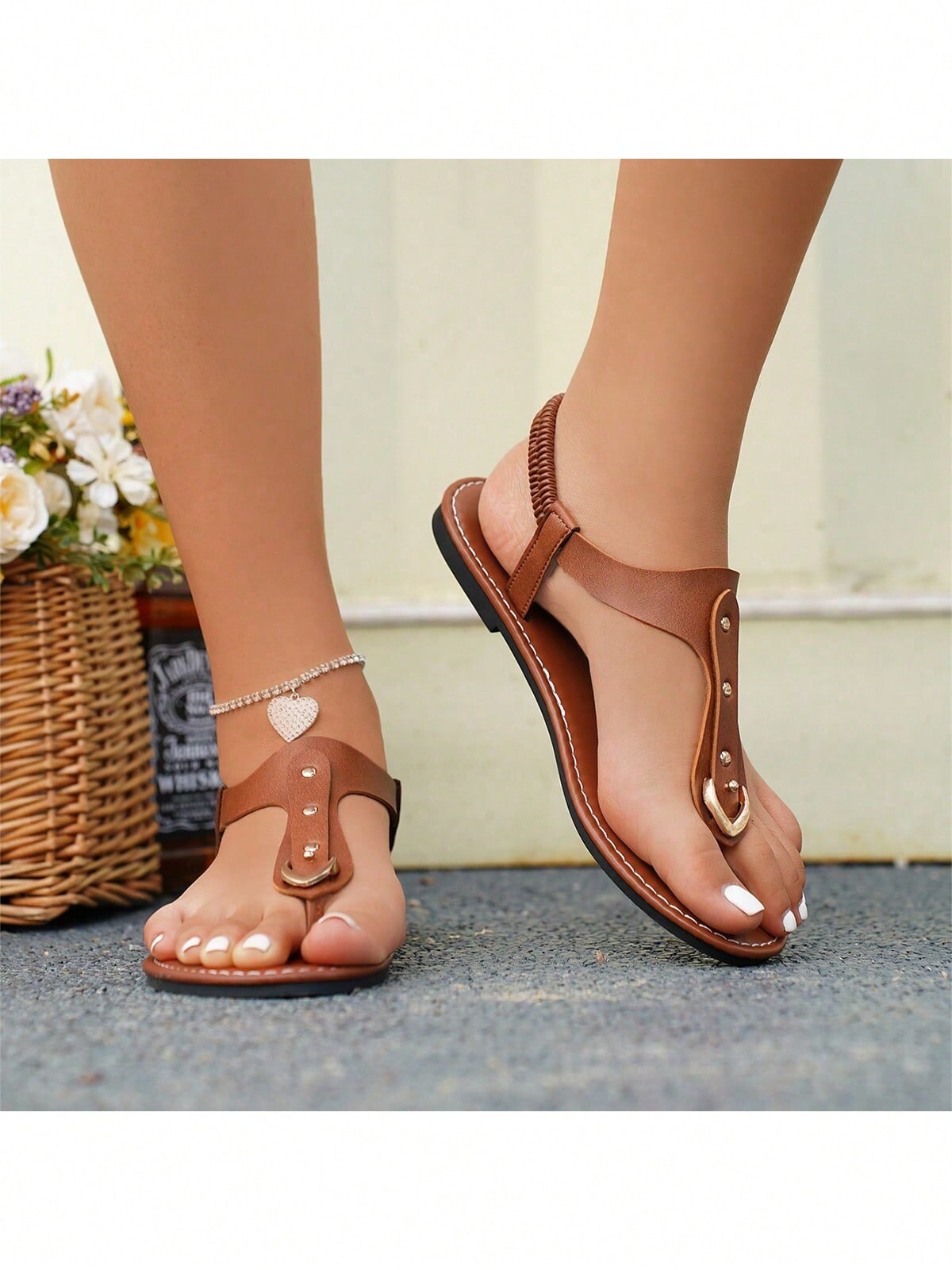 Women's flat slide sandals with rivet decor, elastic strap, buckle detail, and toe post open design for outdoor and beach wear.