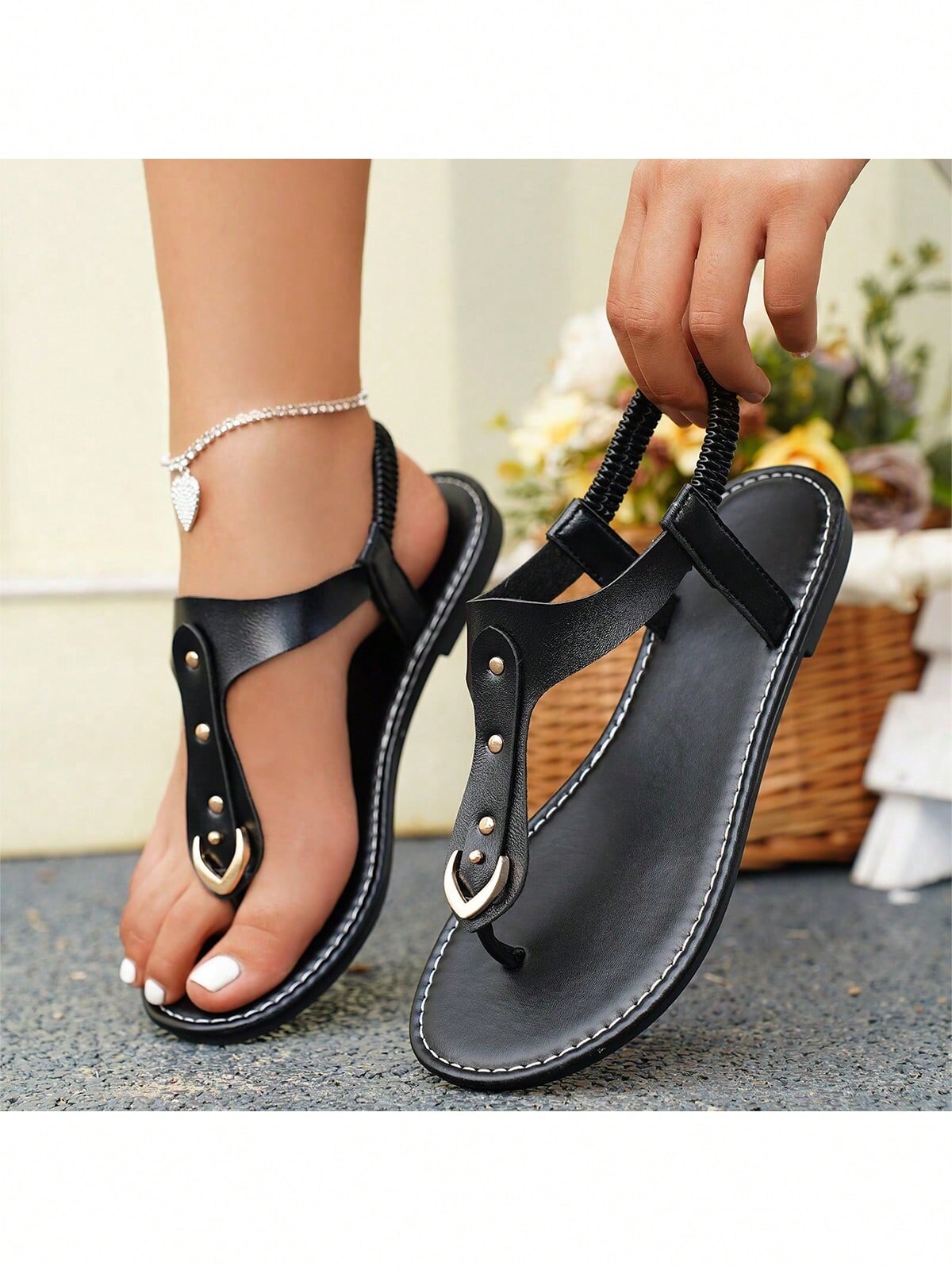 Women's flat slide sandals with rivet decor, elastic strap, buckle detail, and toe post open design for outdoor and beach wear.