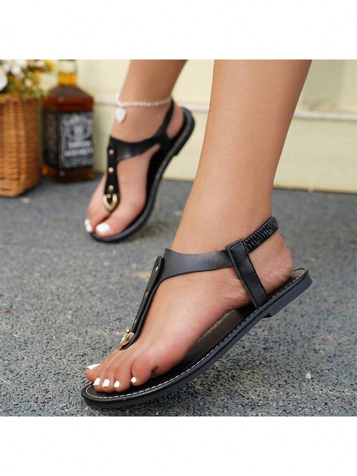 Women's flat slide sandals with rivet decor, elastic strap, buckle detail, and toe post open design for outdoor and beach wear.
