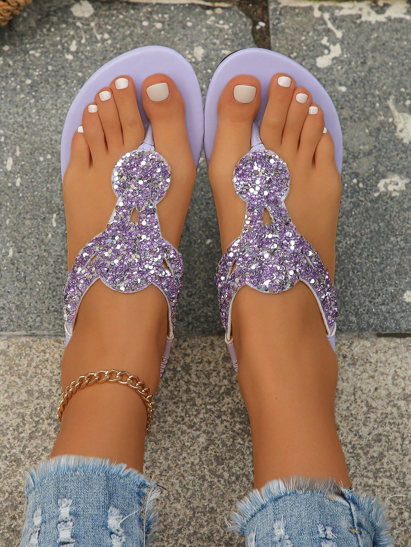 Women’s plus size 35-45 flat thong sandals with elastic strap, round toe shape, textured pattern, and rhinestone asymmetrical detail in slip-on beach style for outdoor summer wear.