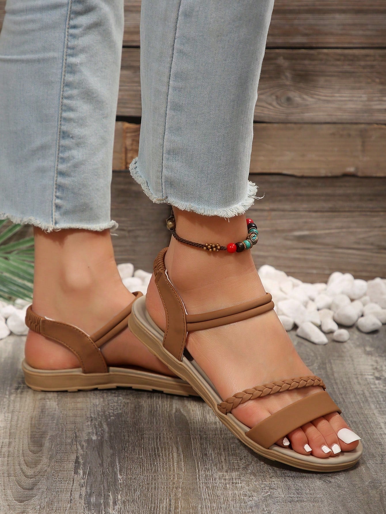 Women’s flat gladiator sandals with braided detail and an open-toe design, suitable for beach and outdoor wear.