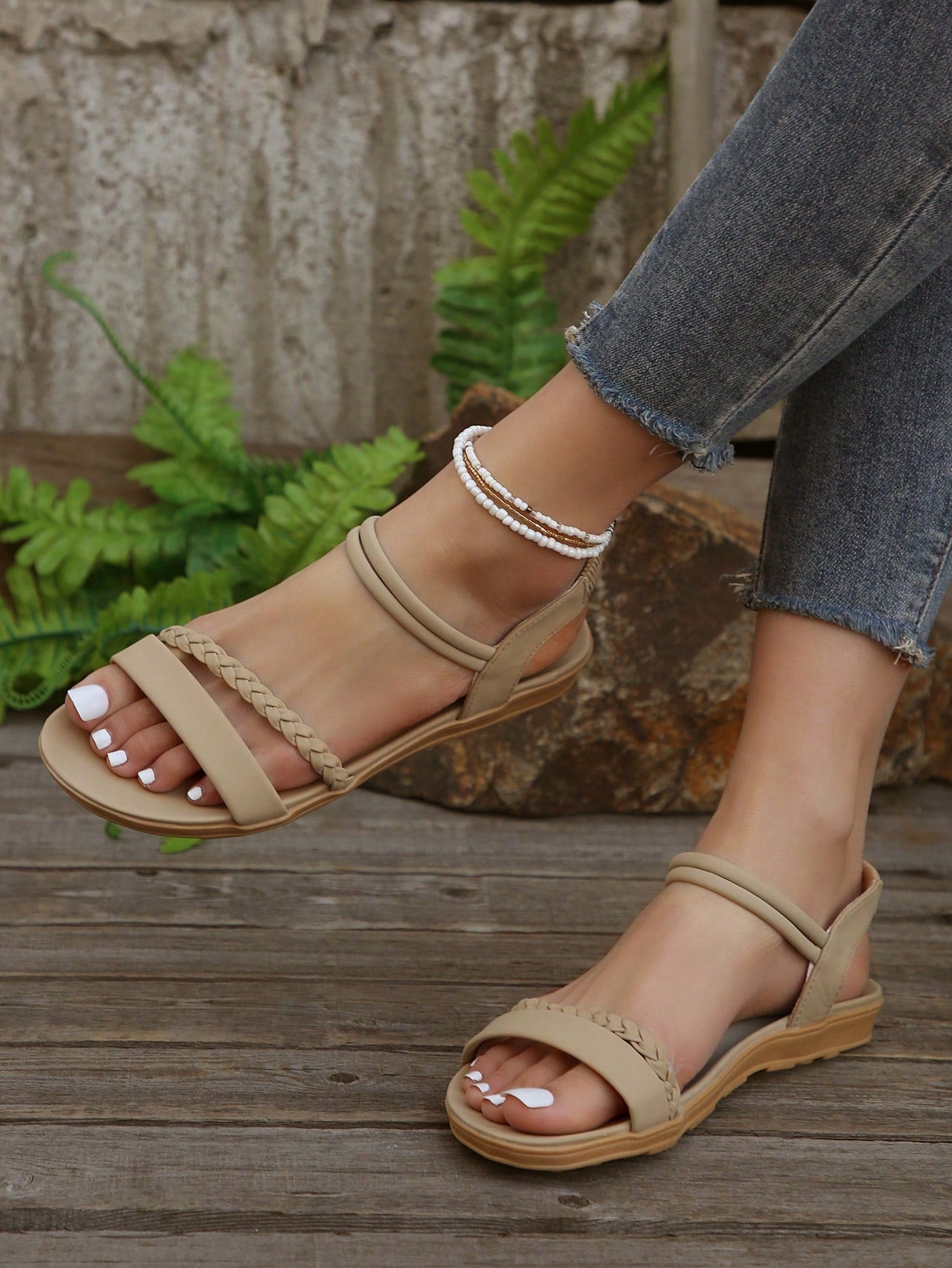 Women’s flat gladiator sandals with braided detail and an open-toe design, suitable for beach and outdoor wear.