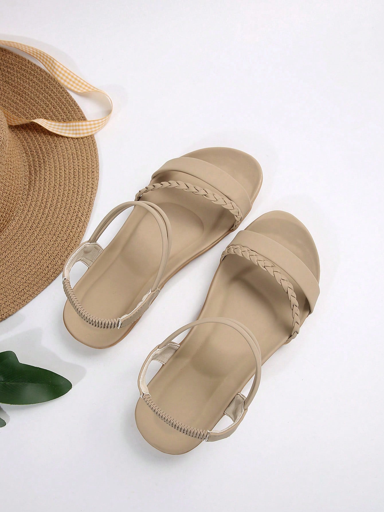 Women’s flat gladiator sandals with braided detail and an open-toe design, suitable for beach and outdoor wear.