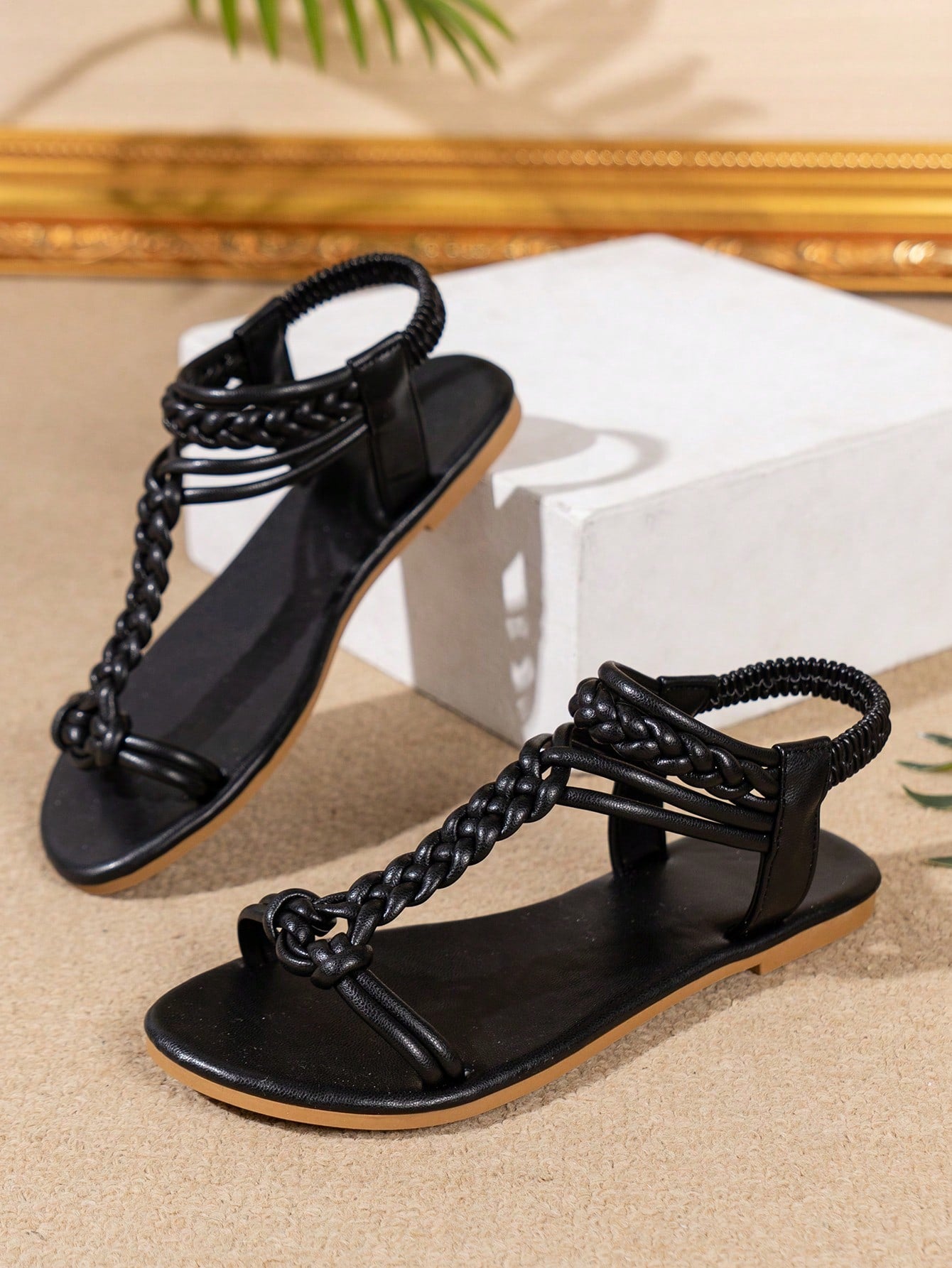 Women’s flat beach sandals with a woven braid band, toe-post thong front, and slingback strap, featuring a plain elegant style and rubber outsole.