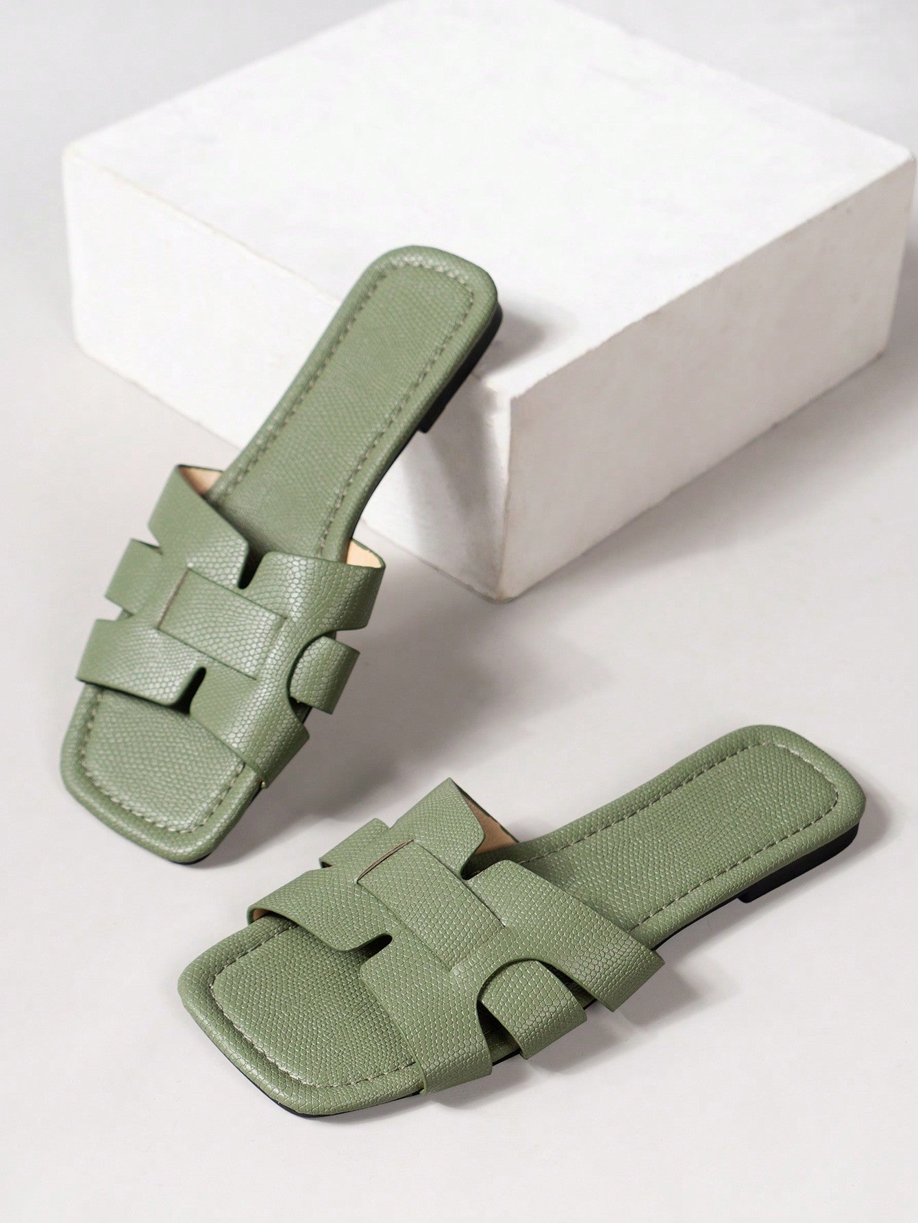 Women's Korean-style casual flat slide sandals with open toe, geometric detail, and pink color.