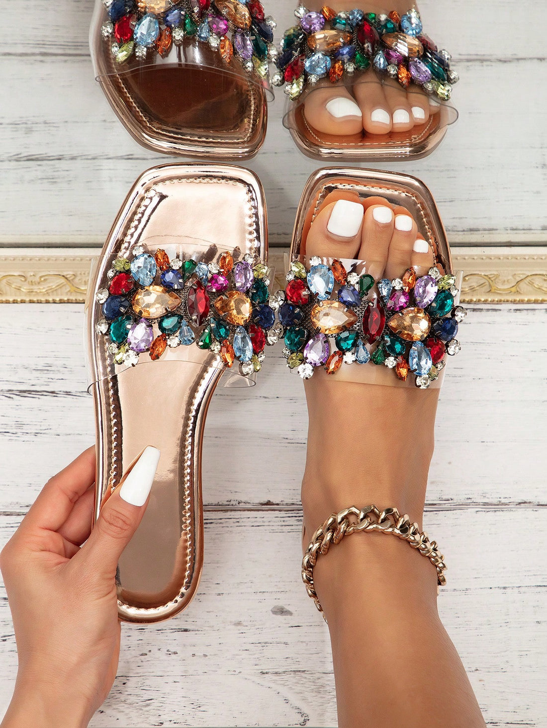 Pair of women’s flat slide sandals with open toe and rhinestone sequin embellishments, designed in a beach-ready style with slip-resistant sole.