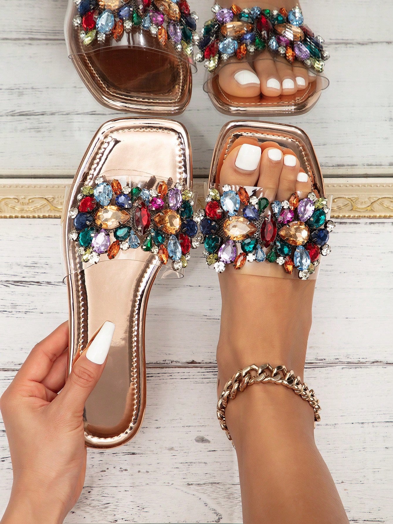 Pair of women’s flat slide sandals with open toe and rhinestone sequin embellishments, designed in a beach-ready style with slip-resistant sole.