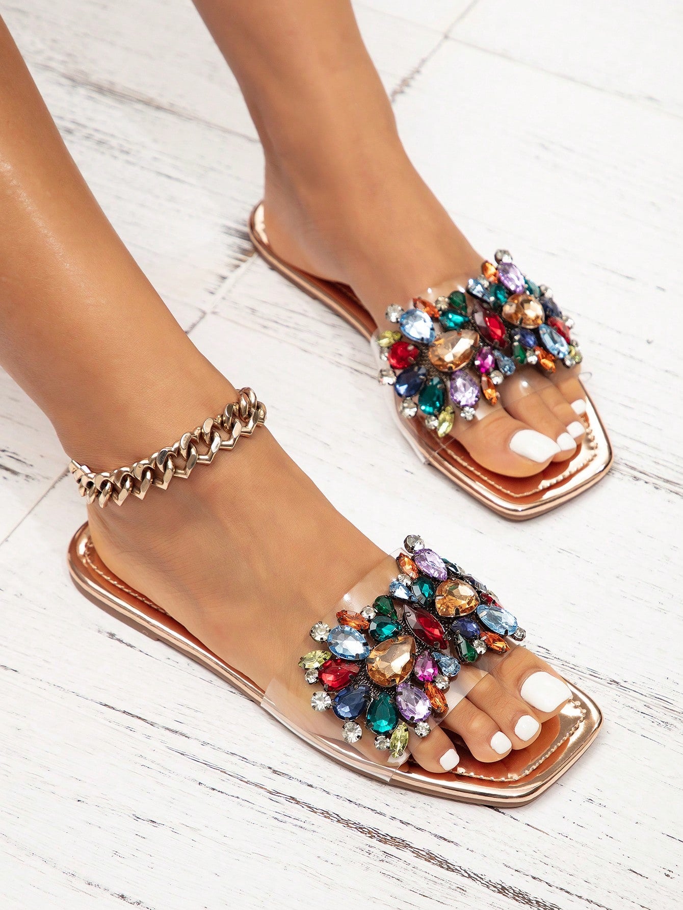 Pair of women’s flat slide sandals with open toe and rhinestone sequin embellishments, designed in a beach-ready style with slip-resistant sole.
