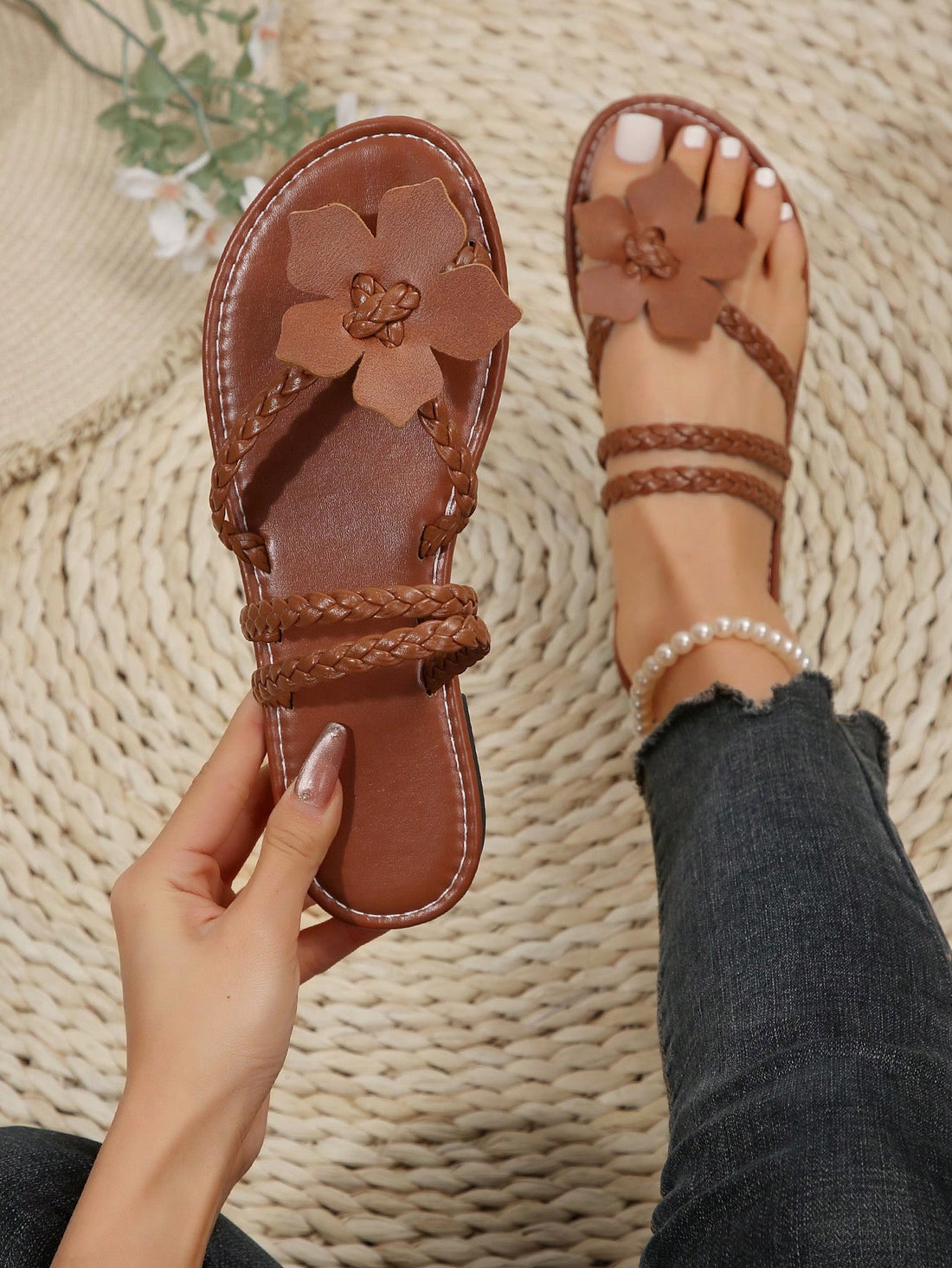 Women's brown floral print flat slide sandals with braided detail and toe-post design, casual beach-ready summer slippers.