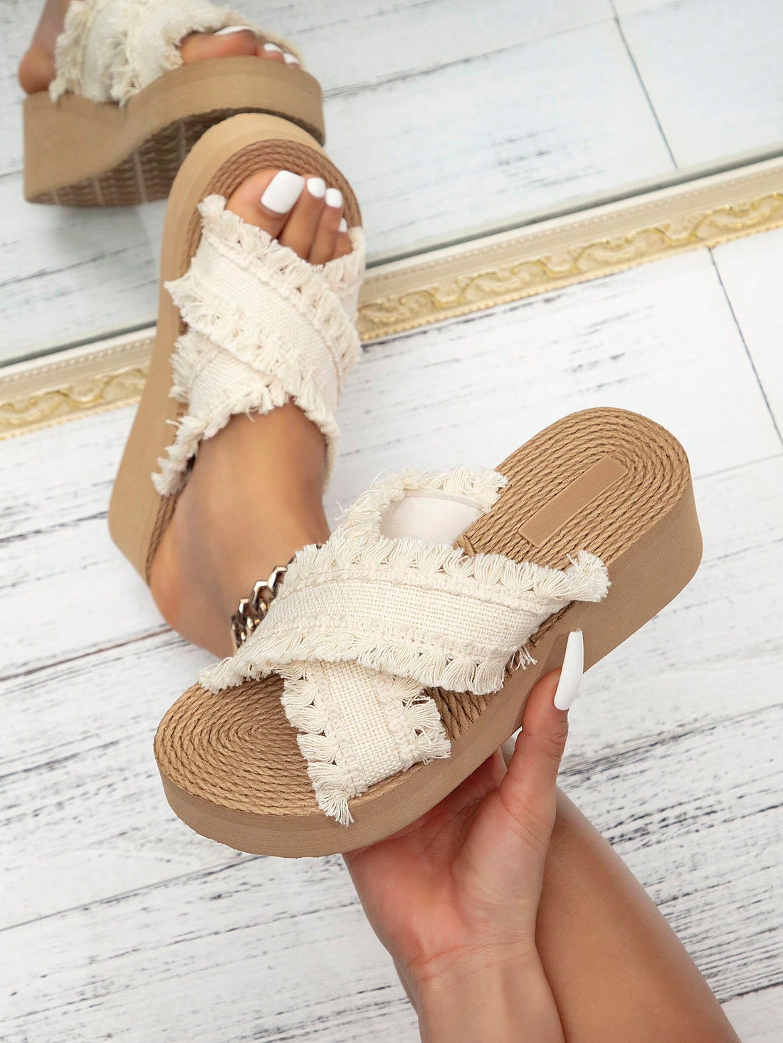 Women's beige slip-on platform wedge slide sandals with open toe, tassel and ruffle details, rope-pattern styling, and mid heel.