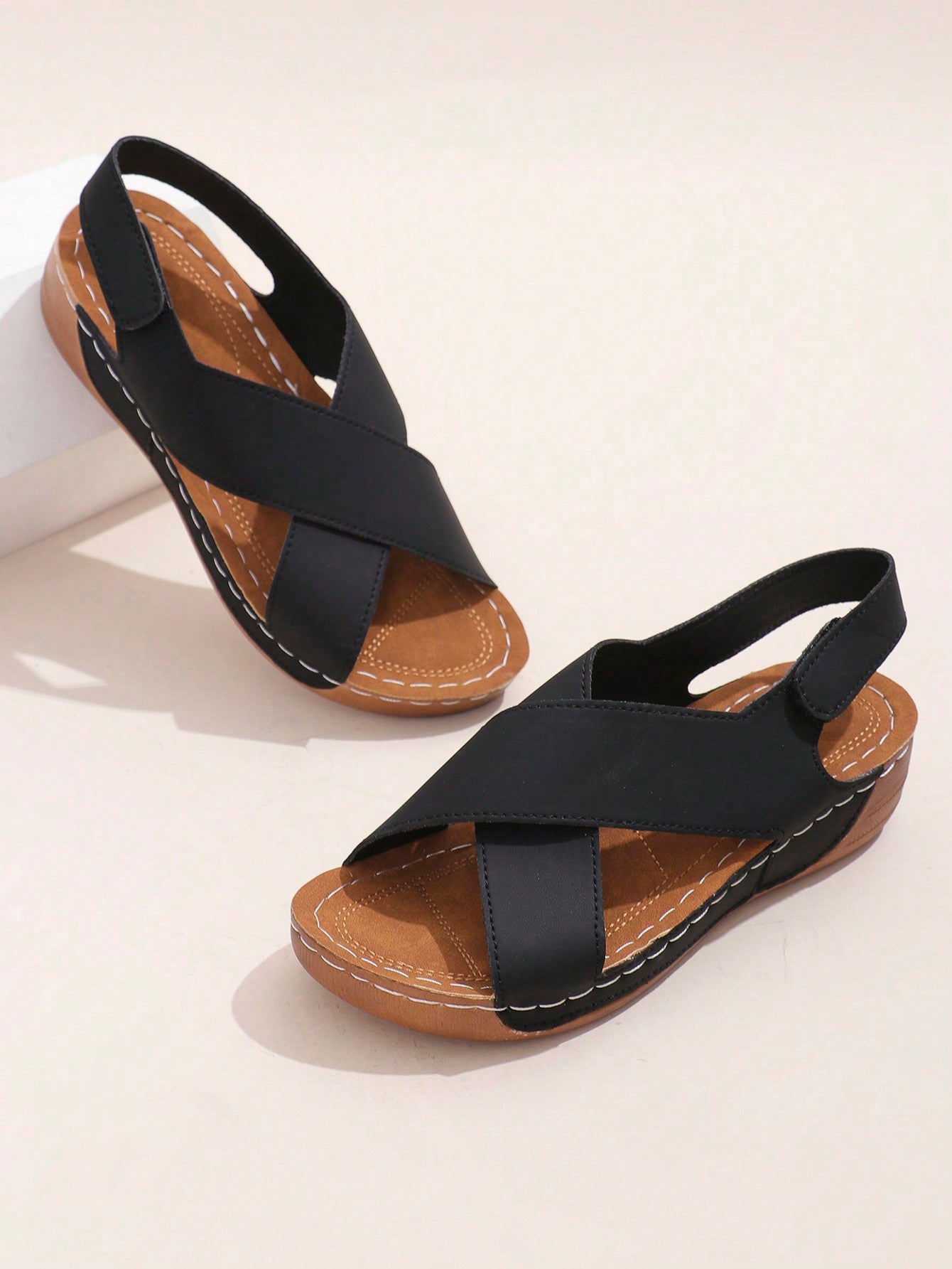 Women's open-toe wedge slide sandals with studded hollow-out upper, cross-over straps, buckle closure, and thick soft sole