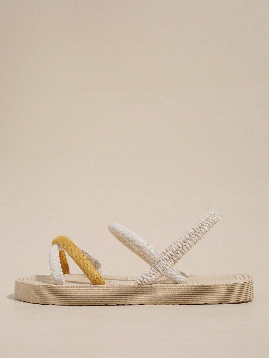 Women's colorblock flat slide sandals with criss cross strap, toe post, cloth tape and fleece detail, finished with sequin, crystal, gemstone, and knot accents.