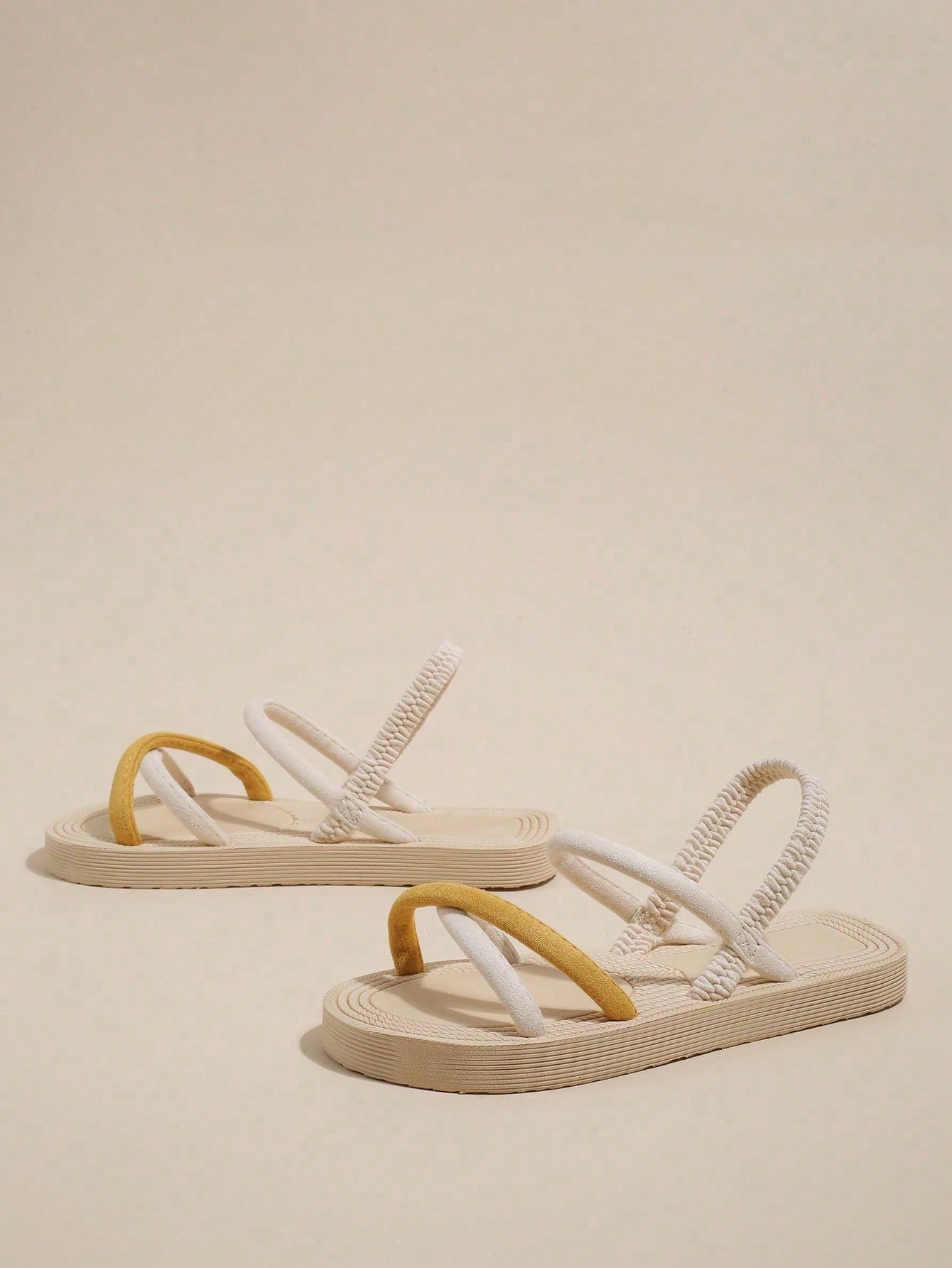 Women's colorblock flat slide sandals with criss cross strap, toe post, cloth tape and fleece detail, finished with sequin, crystal, gemstone, and knot accents.