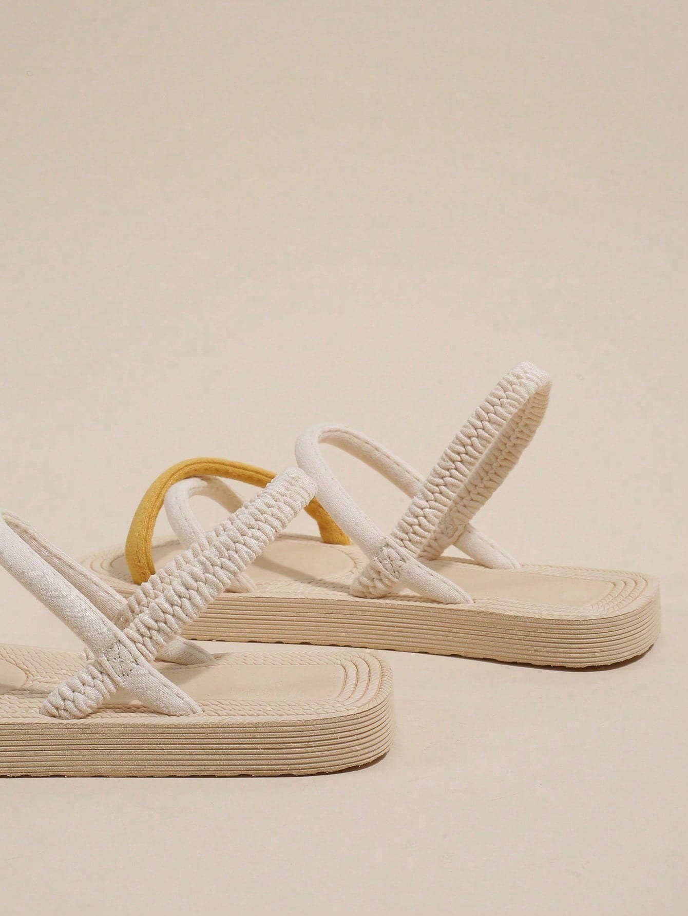 Women's colorblock flat slide sandals with criss cross strap, toe post, cloth tape and fleece detail, finished with sequin, crystal, gemstone, and knot accents.