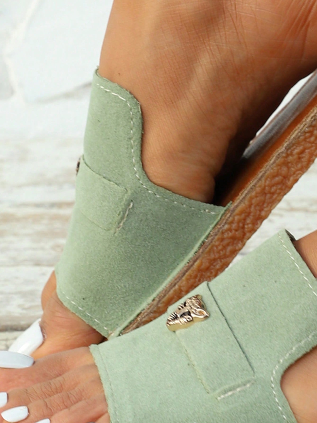 Women's flat slide sandals featuring a fabric strap with bow pendant, visible stitching detail, and open-toe design in a casual beach and vacation style.