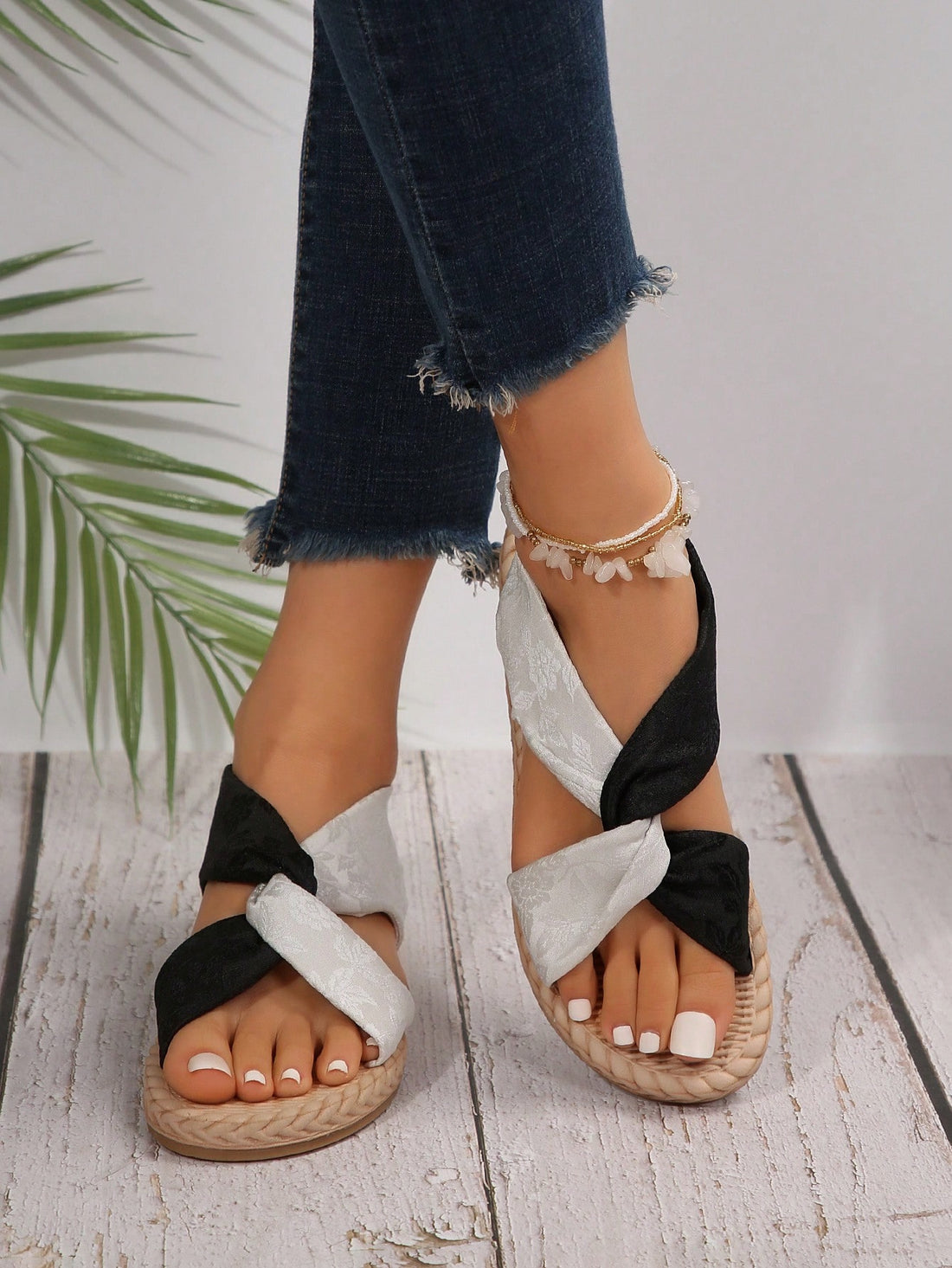 Women's flat gladiator sandals with twist strap detail, crossed-back straps, and open toe design for beach and outdoor wear.