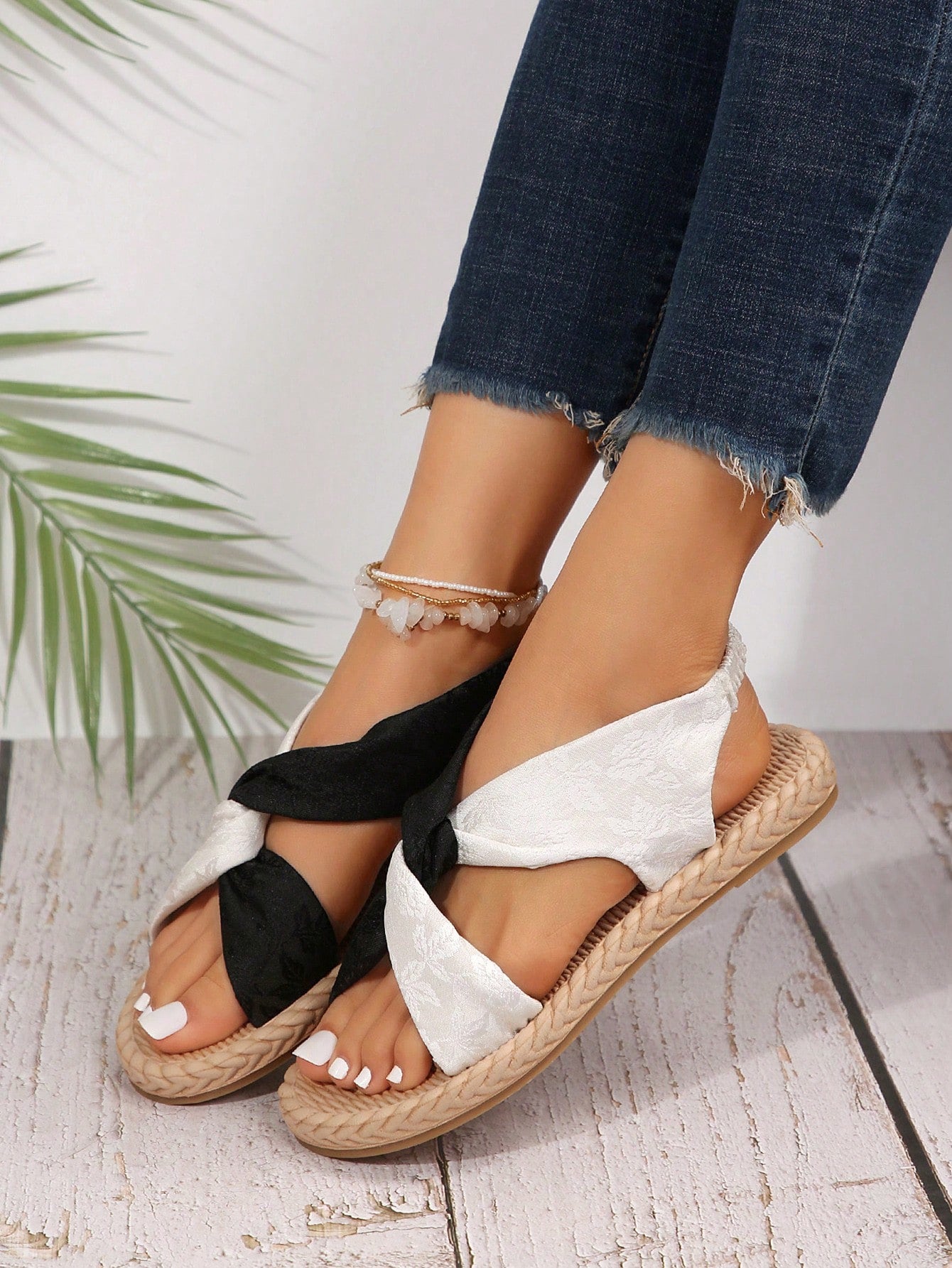 Women's flat gladiator sandals with twist strap detail, crossed-back straps, and open toe design for beach and outdoor wear.