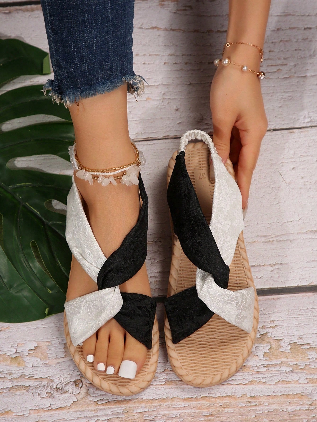 Women's flat gladiator sandals with twist strap detail, crossed-back straps, and open toe design for beach and outdoor wear.