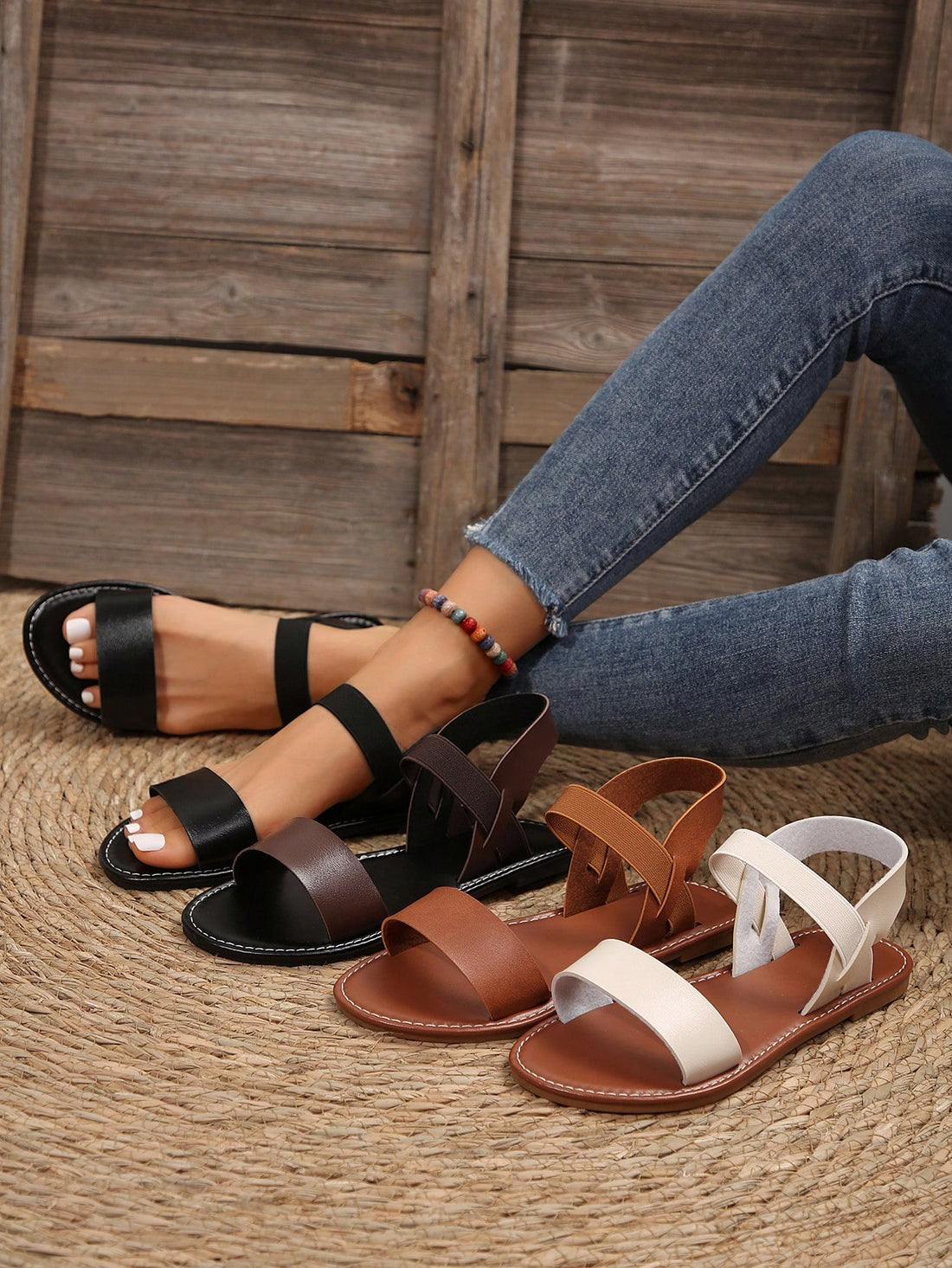 Women’s flat slide sandals with cut-out Roman-style straps and open-toe design, suitable for casual beach and home wear.