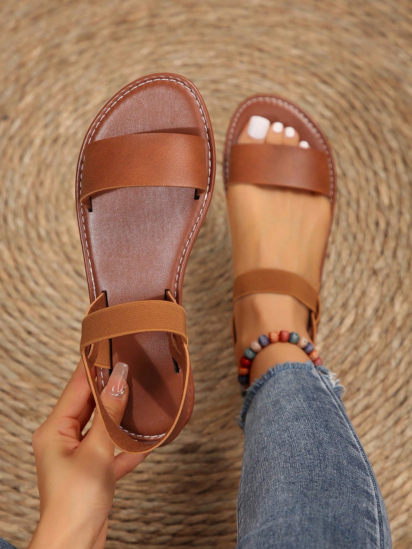 Women’s flat slide sandals with cut-out Roman-style straps and open-toe design, suitable for casual beach and home wear.