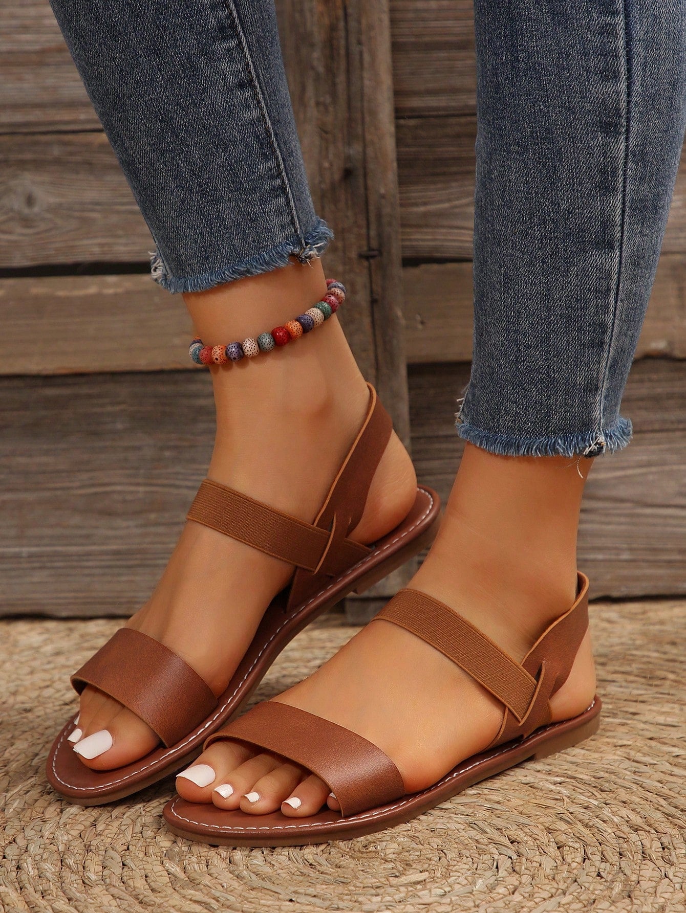 Women’s flat slide sandals with cut-out Roman-style straps and open-toe design, suitable for casual beach and home wear.