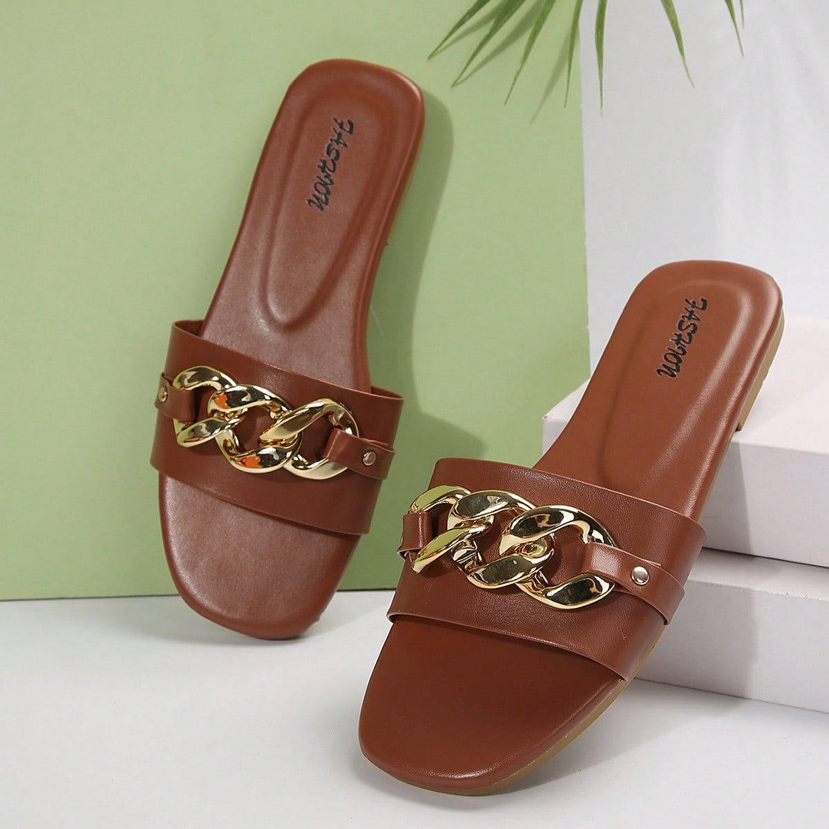 Women's gold-tone slip-on slide sandals with open toe and chain link detailing, shown as casual flat sandals for indoor and outdoor use.