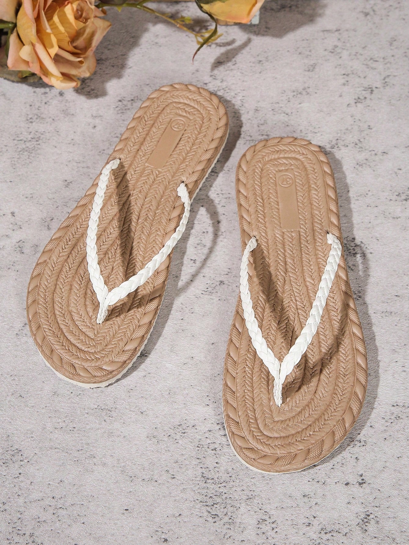Women's braided flat thong sandals with toe post and slip-on slide design, suitable for casual outdoor and beach use.
