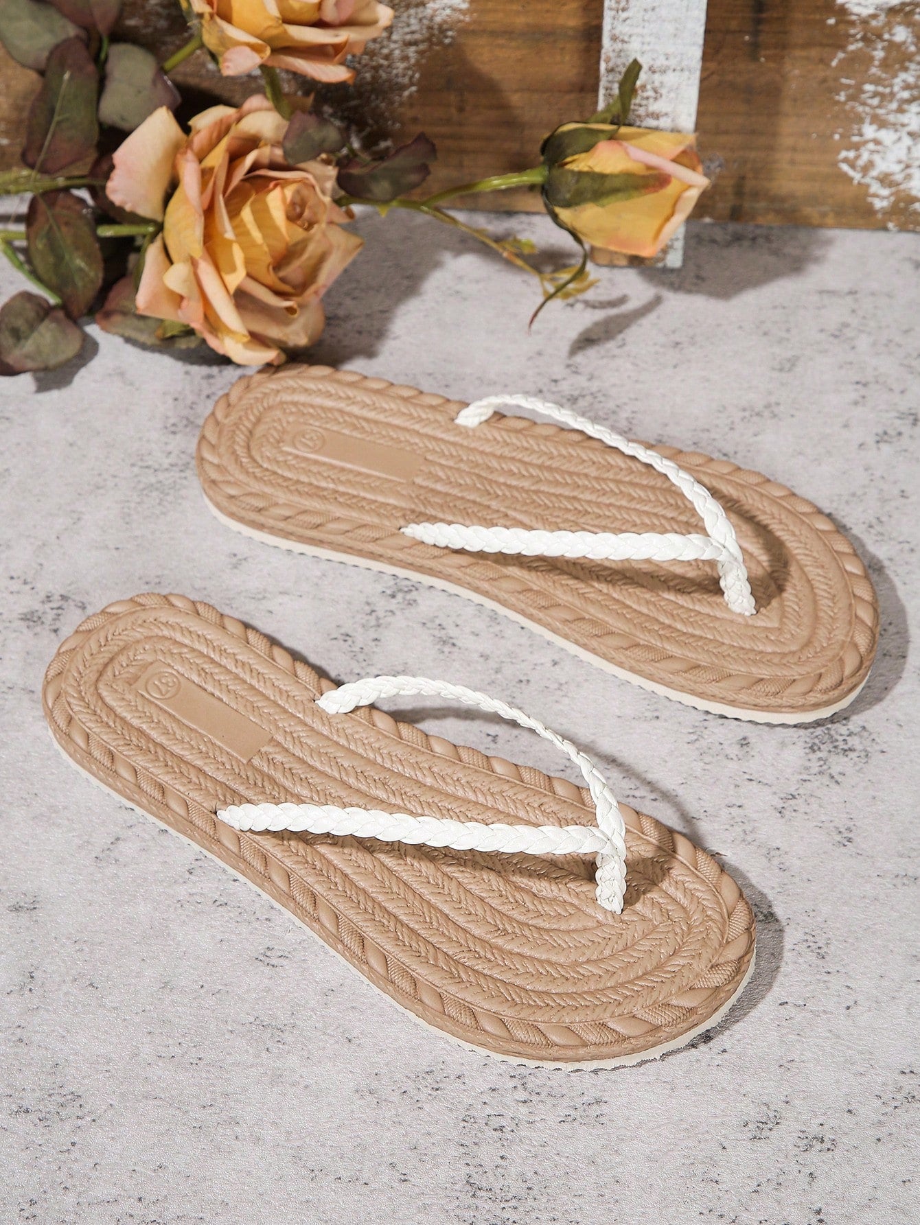 Women's braided flat thong sandals with toe post and slip-on slide design, suitable for casual outdoor and beach use.