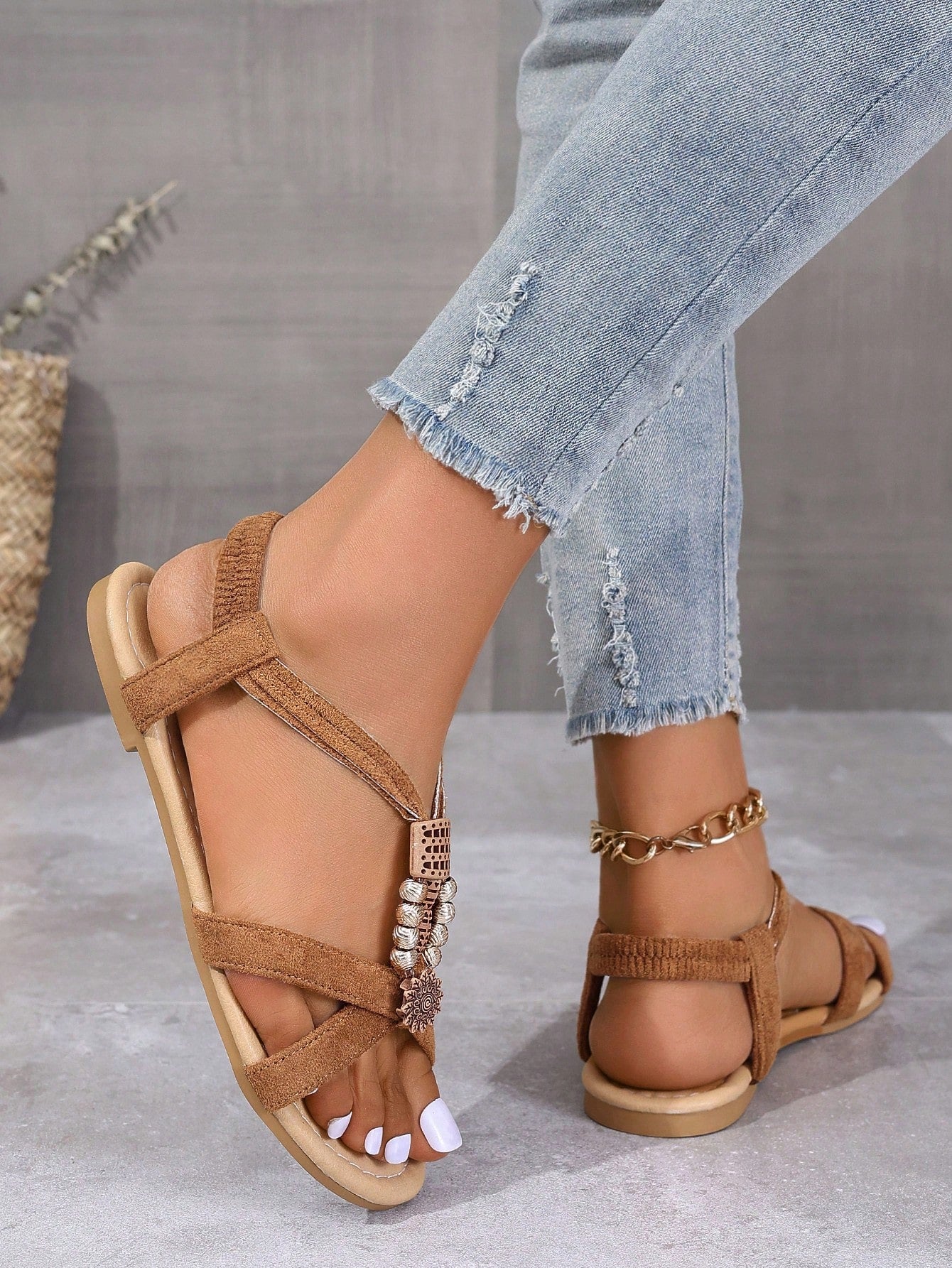 Women's bohemian flat slingback sandals with braided beaded details and open toe, designed for beach and vacation outfits.