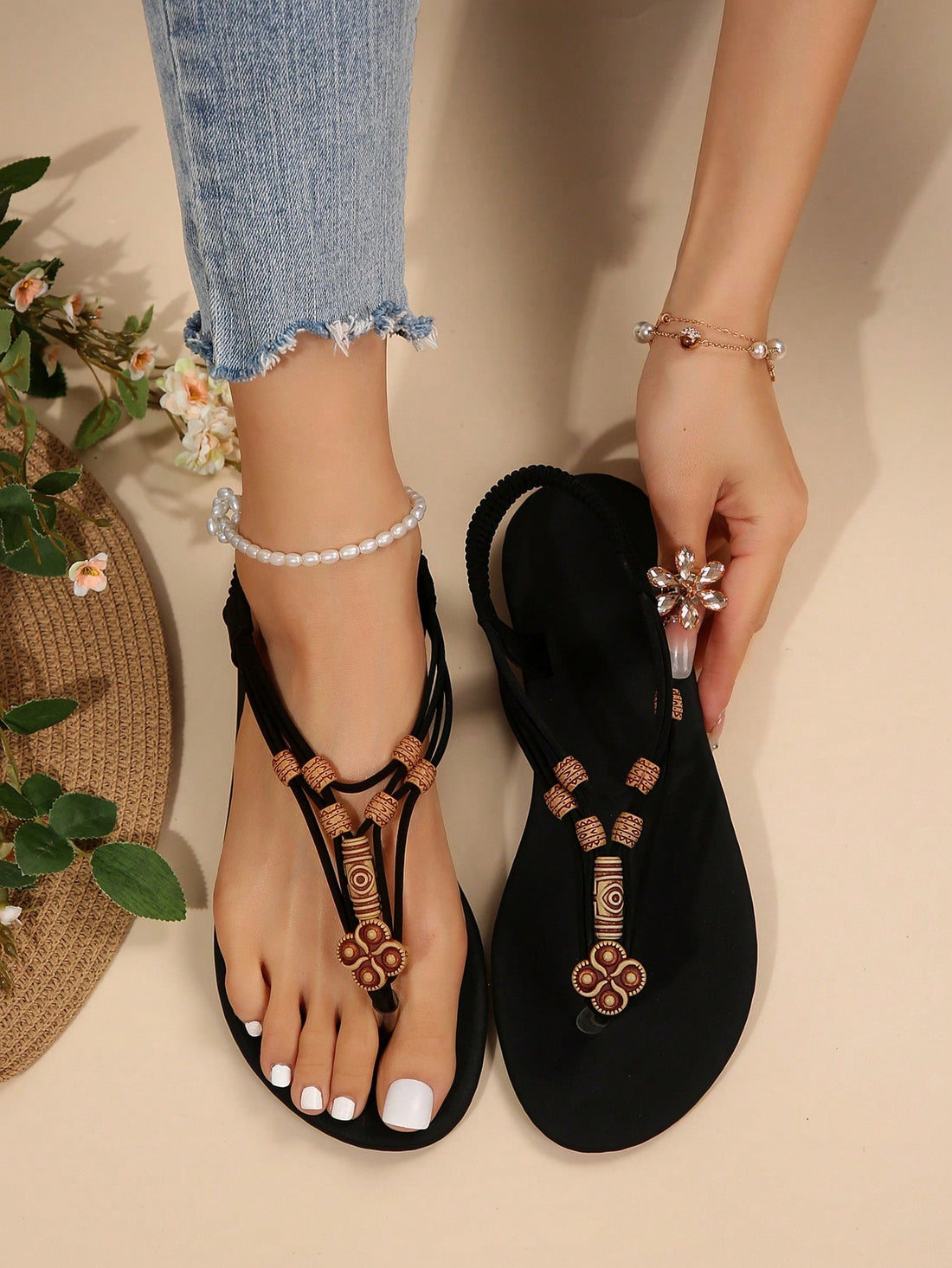 Women's flat gladiator sandals with beaded toe ring and toe post, designed for beach and vacation outfits.