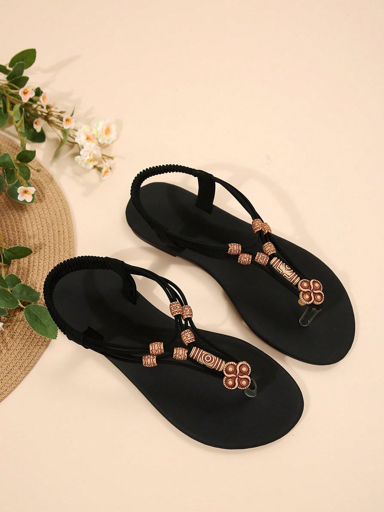 Women's flat gladiator sandals with beaded toe ring and toe post, designed for beach and vacation outfits.