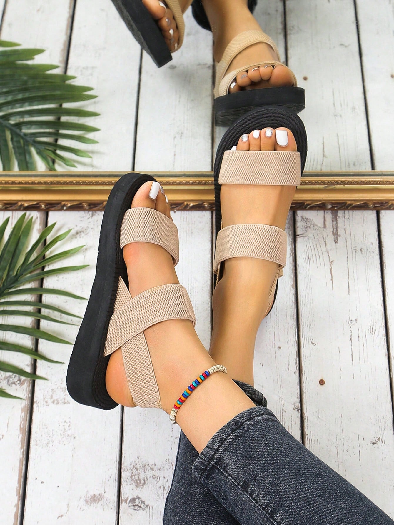 Women's minimalist double strap slingback wedge sandals with open toe and slip-on design.