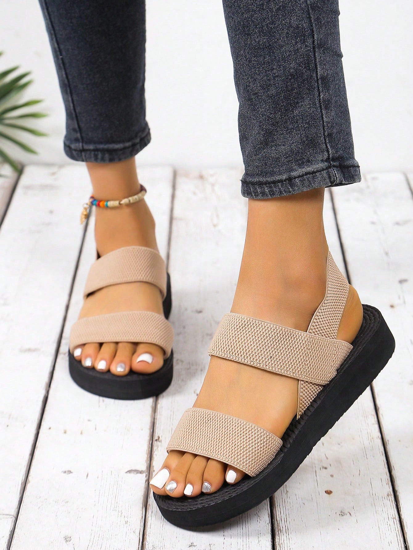 Women's minimalist double strap slingback wedge sandals with open toe and slip-on design.