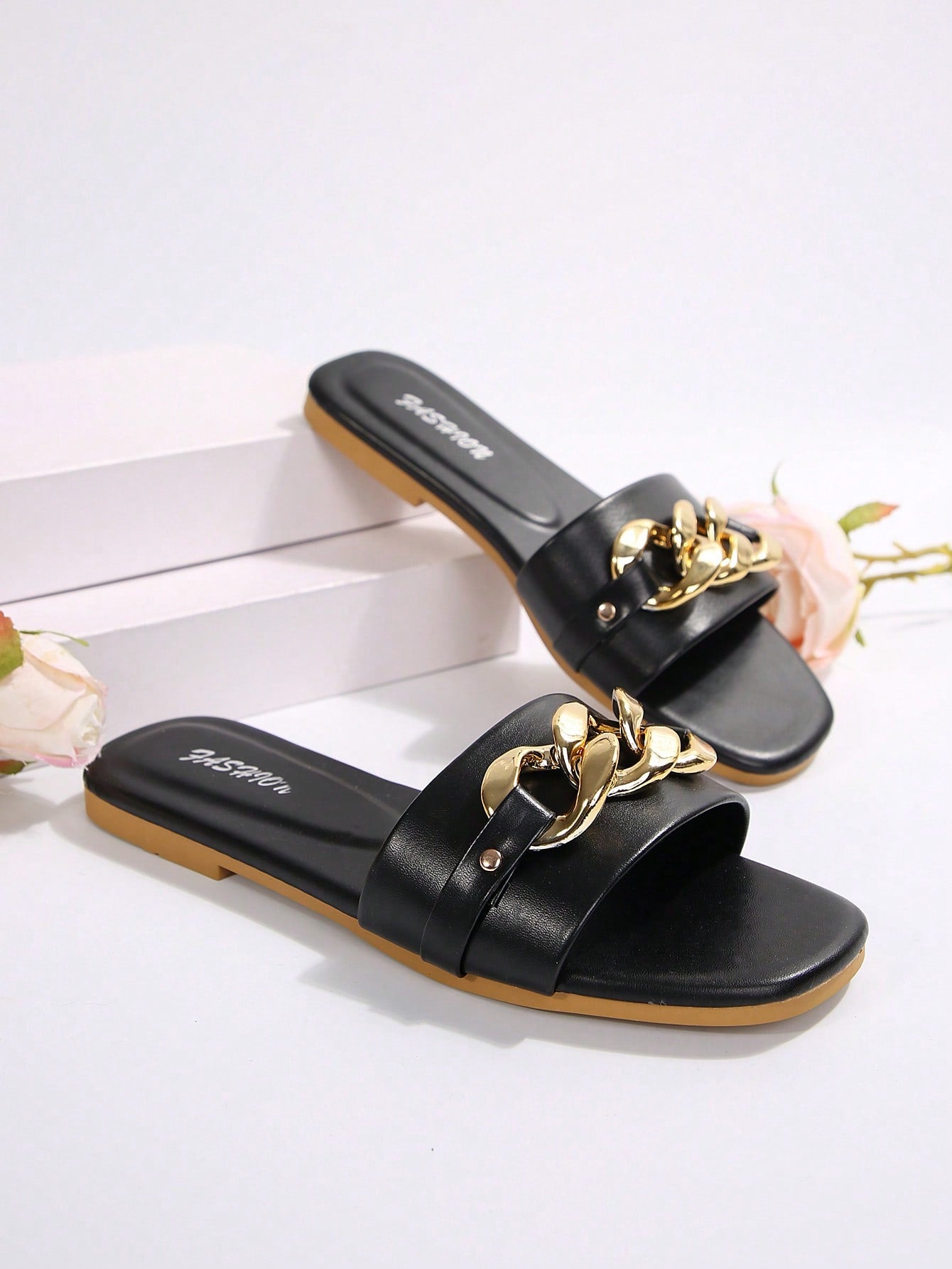 Women's gold-tone slip-on slide sandals with open toe and chain link detailing, shown as casual flat sandals for indoor and outdoor use.