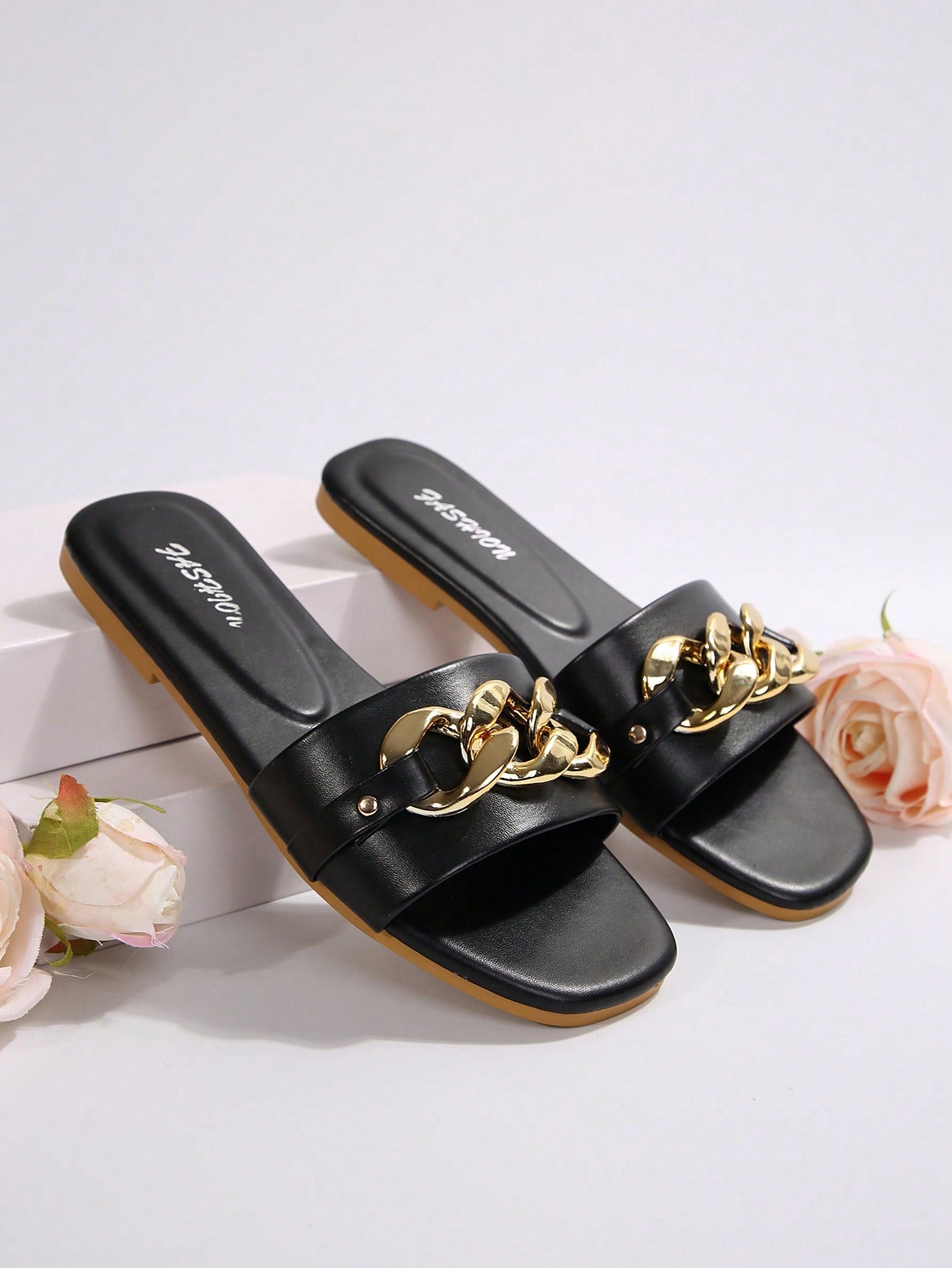 Women's gold-tone slip-on slide sandals with open toe and chain link detailing, shown as casual flat sandals for indoor and outdoor use.
