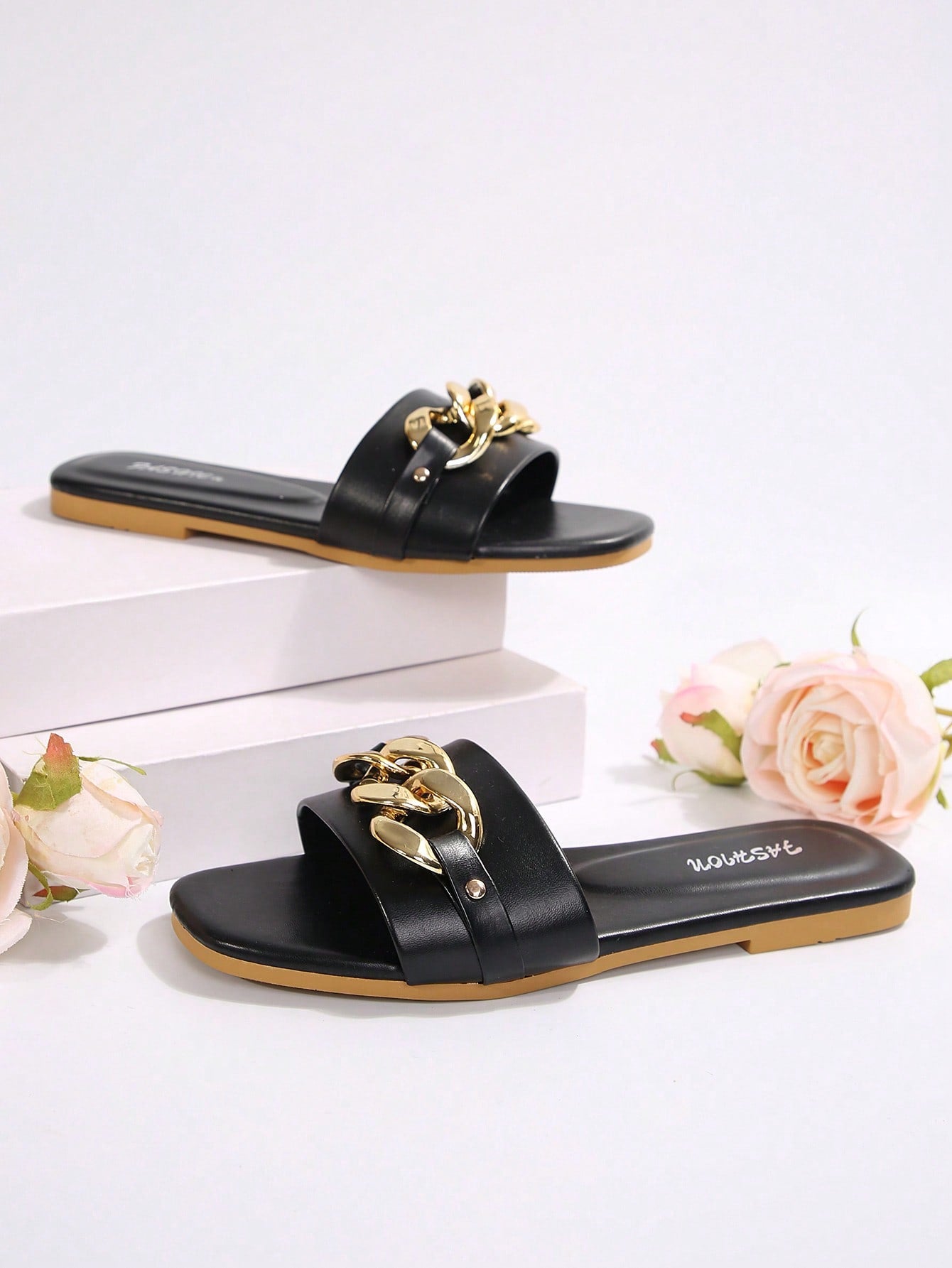Women's gold-tone slip-on slide sandals with open toe and chain link detailing, shown as casual flat sandals for indoor and outdoor use.