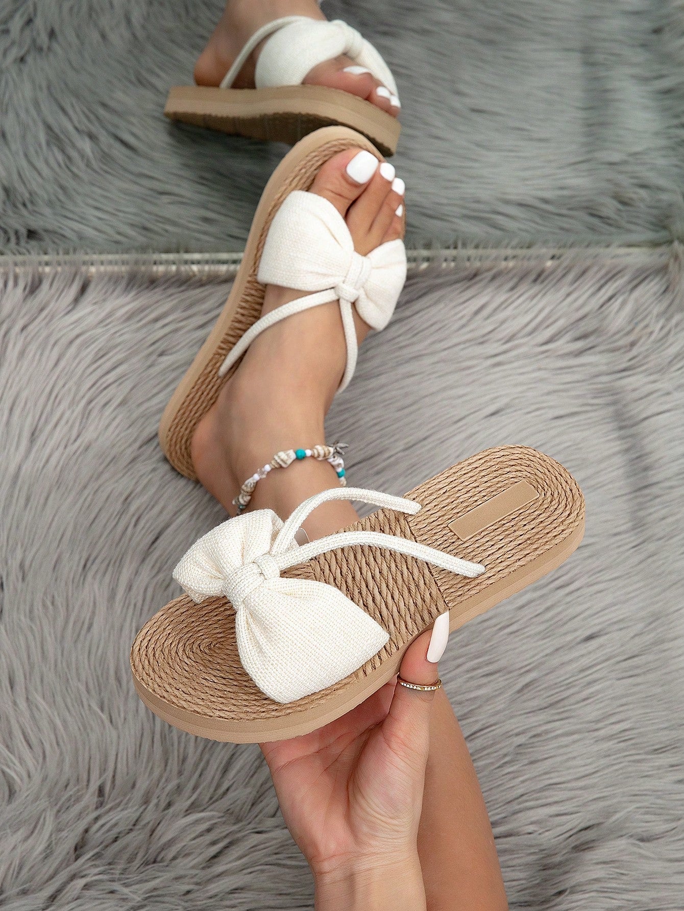 Women's beige flat open-toe slide sandals with ruched bow and fringe detail, casual breathable fabric style for outdoor, commute, vacation, and home wear