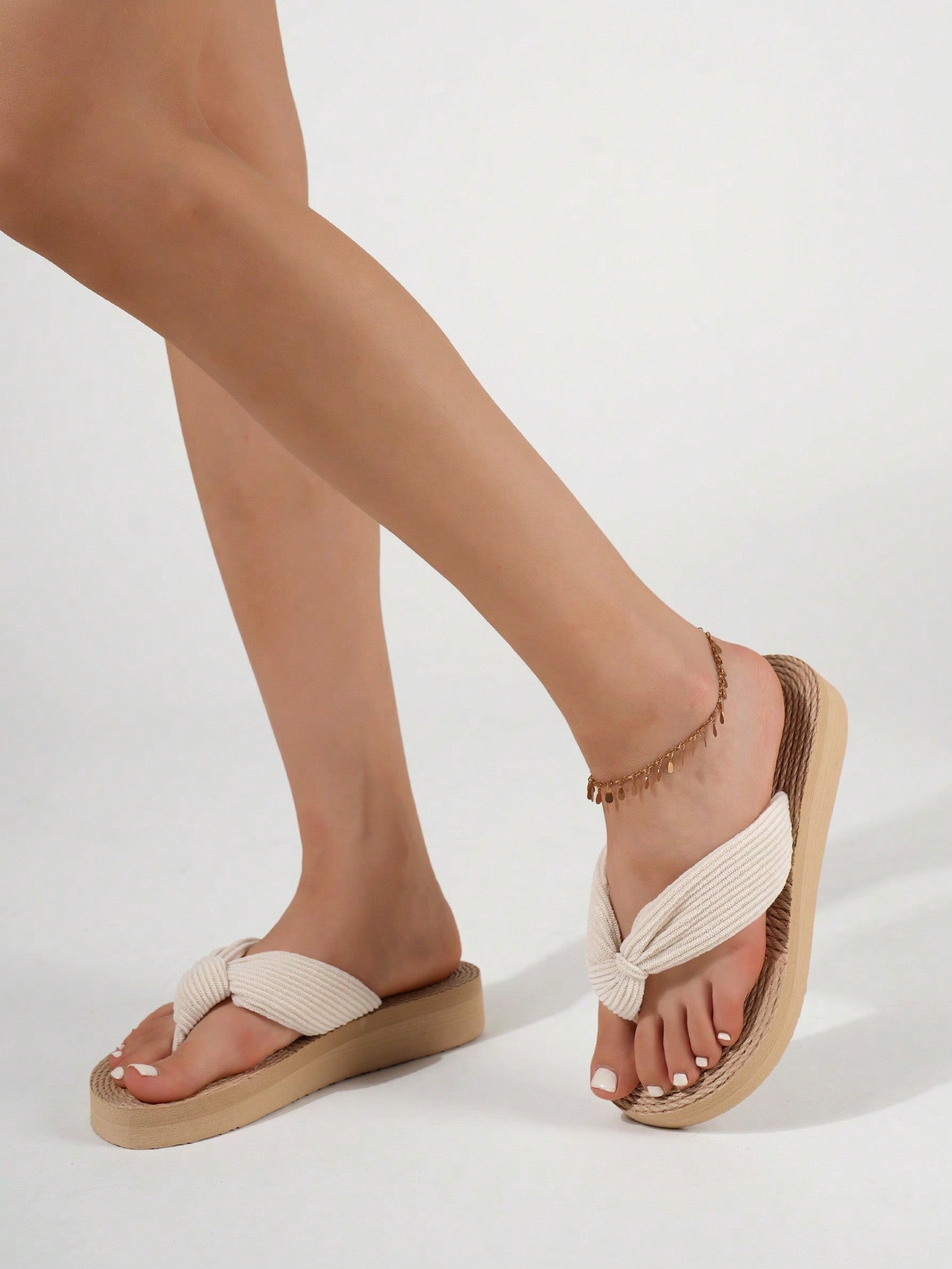 Women's wedge flip flops with braided thong strap, low heel, and thick sole in a casual minimalist outdoor style.