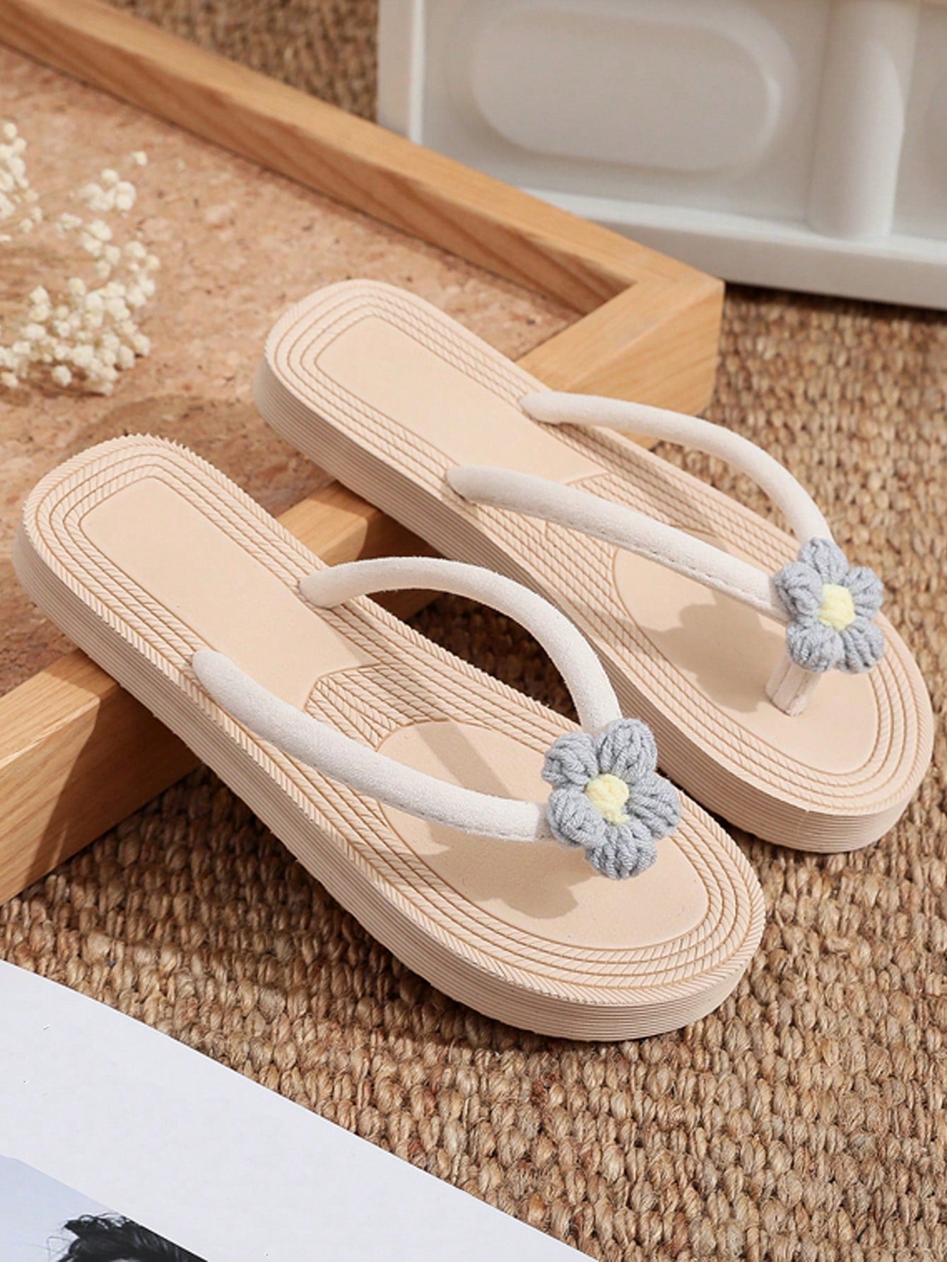 Women's casual flat thong flip flop sandals with minimalist design and applique detail, suitable for outdoor and beach holiday wear.
