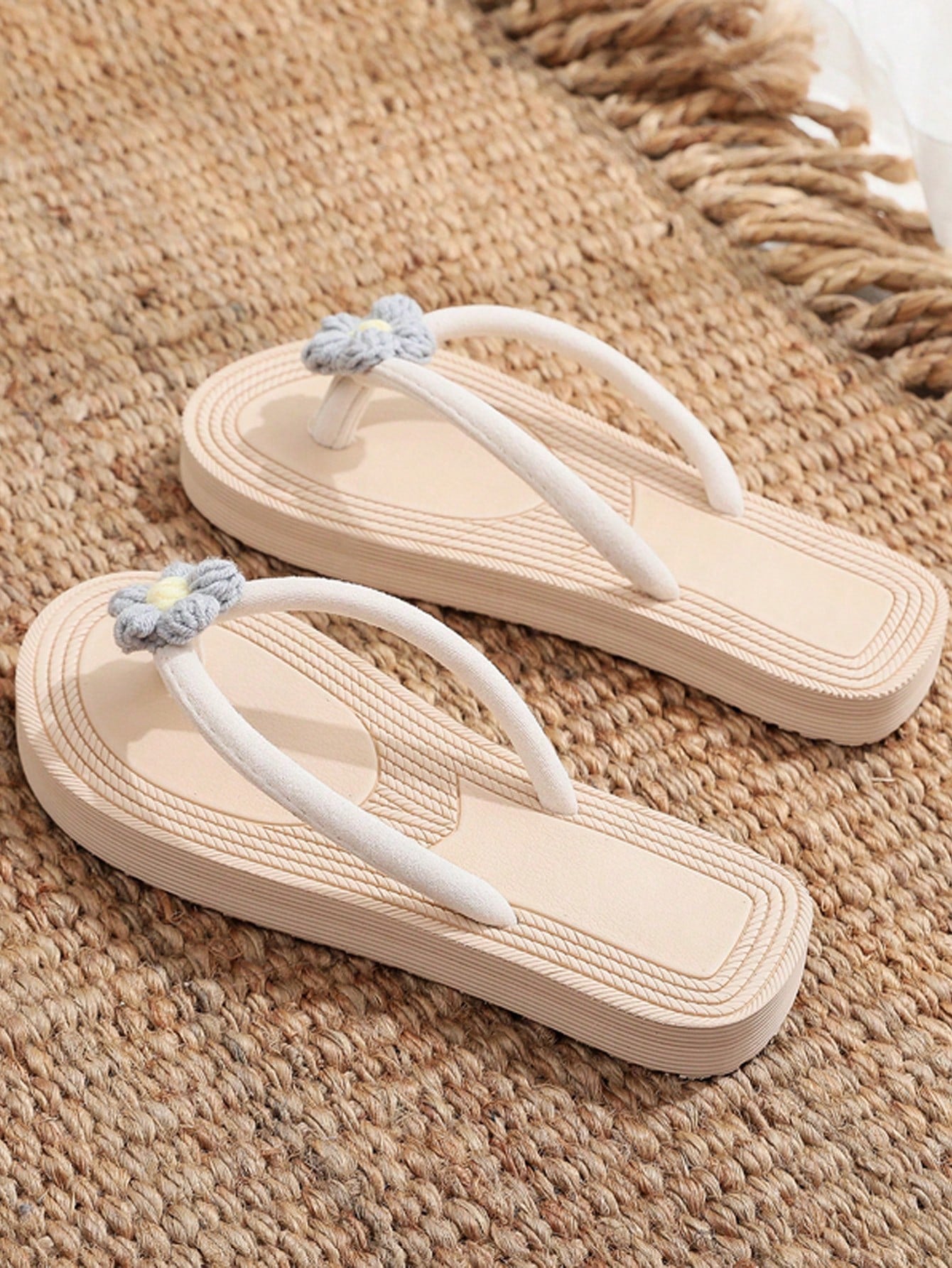 Women's casual flat thong flip flop sandals with minimalist design and applique detail, suitable for outdoor and beach holiday wear.