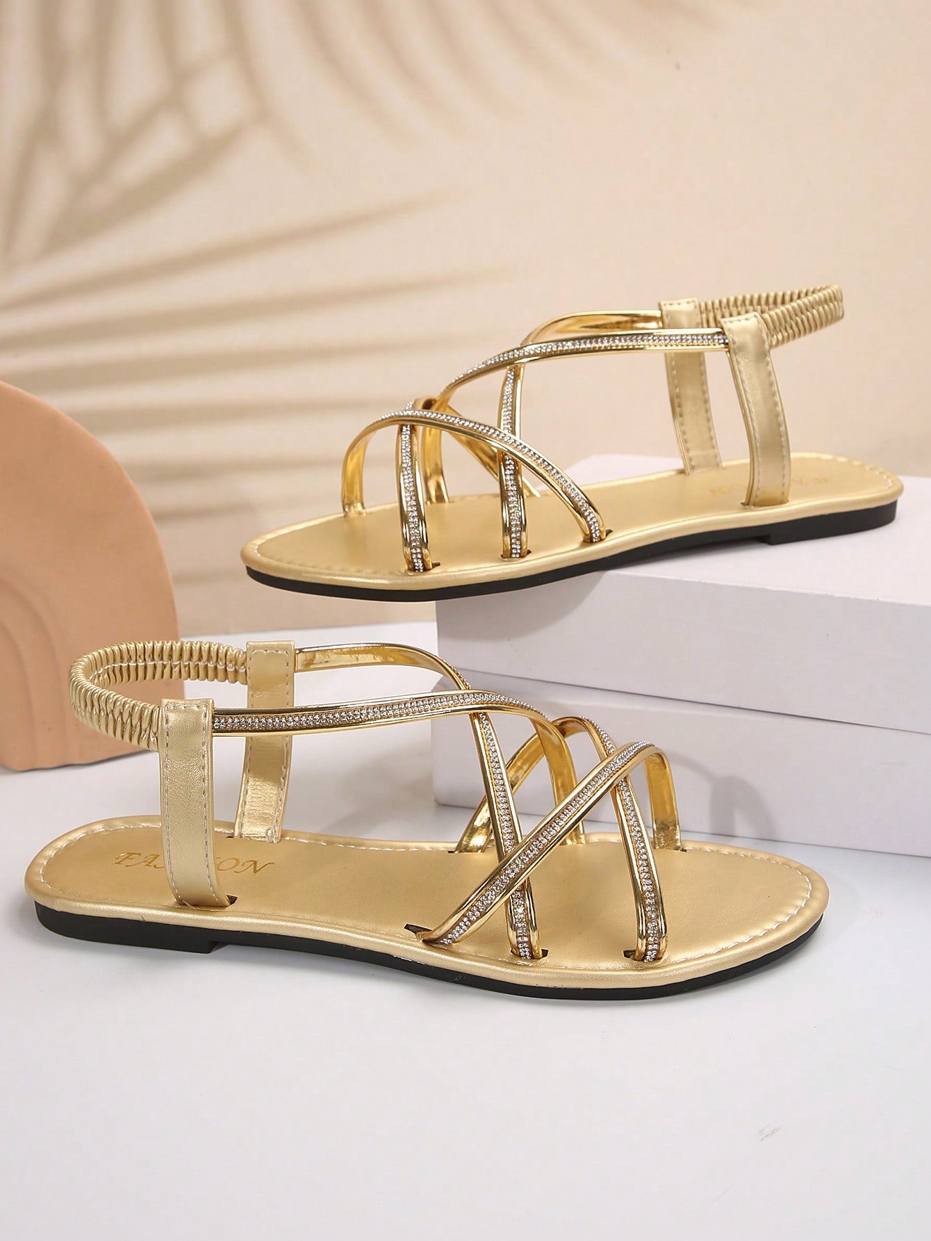 Women's plus size flat slide sandals with open toe, cross straps, rhinestone embellishment, and elastic band detail, suitable for casual beach and outdoor summer wear.