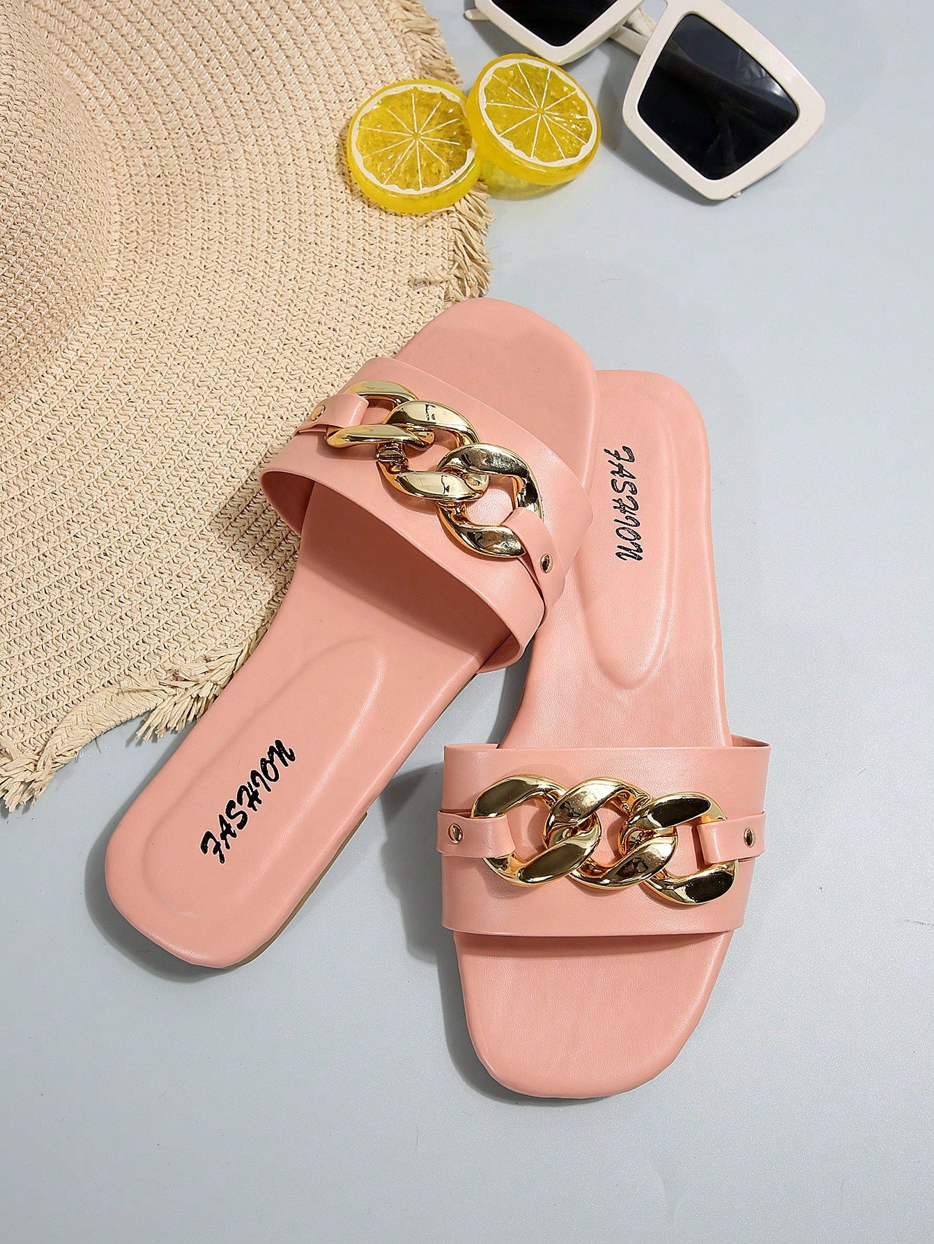 Women's gold-tone slip-on slide sandals with open toe and chain link detailing, shown as casual flat sandals for indoor and outdoor use.