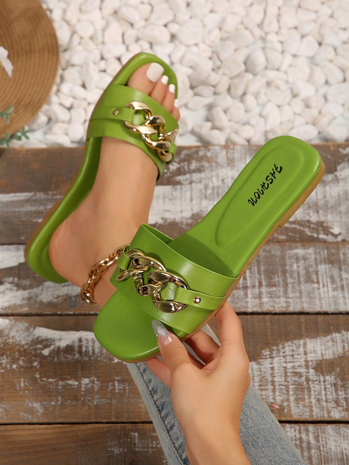 Women's gold-tone slip-on slide sandals with open toe and chain link detailing, shown as casual flat sandals for indoor and outdoor use.