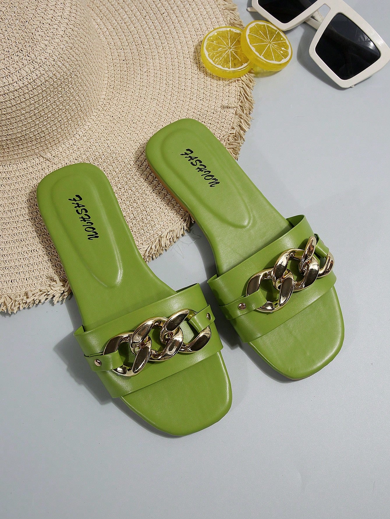 Women's gold-tone slip-on slide sandals with open toe and chain link detailing, shown as casual flat sandals for indoor and outdoor use.