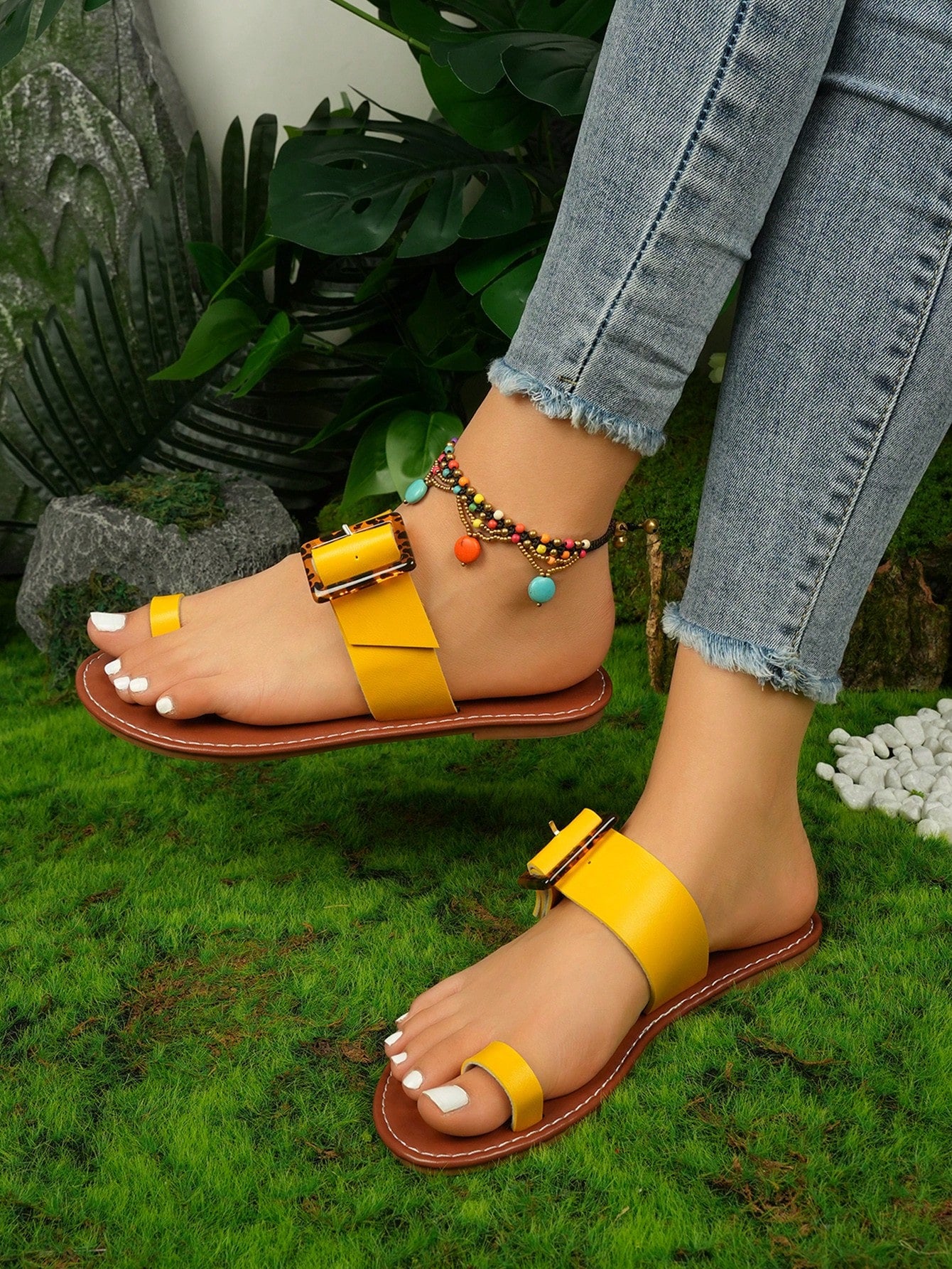 Women's flat slide sandals with leopard print styling, antique-style square buckle detail, and toe post design.