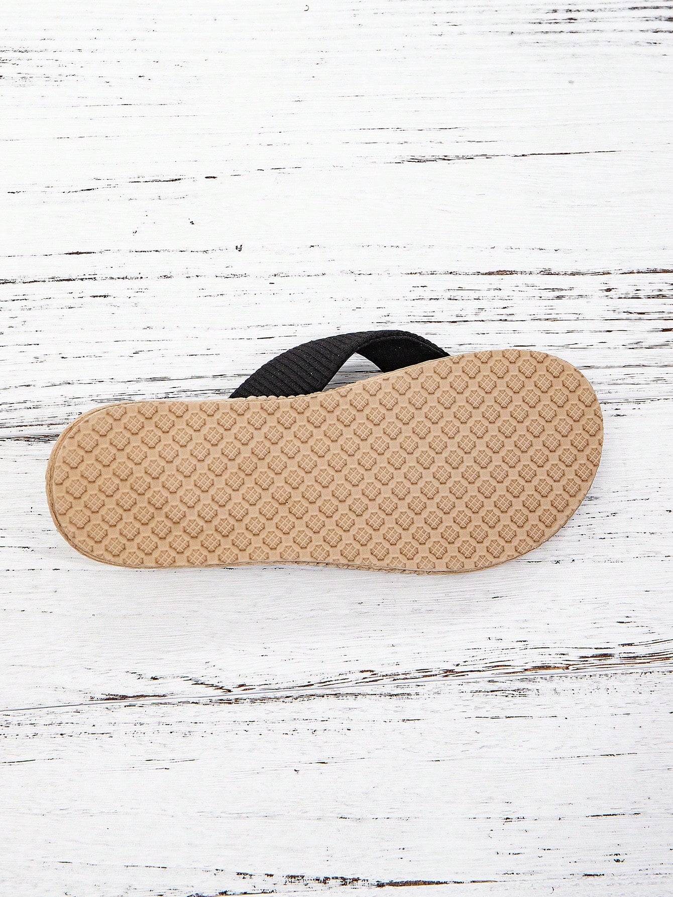 Women’s khaki flat flip-flop sandal with woven braided pattern and casual beach style.