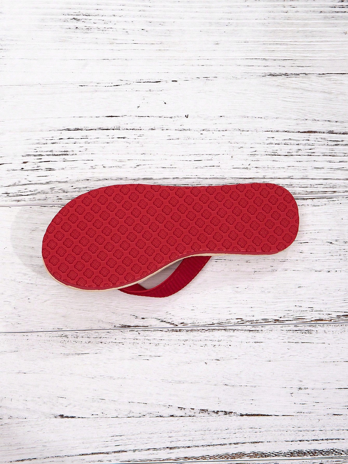 Women’s khaki flat flip-flop sandal with woven braided pattern and casual beach style.
