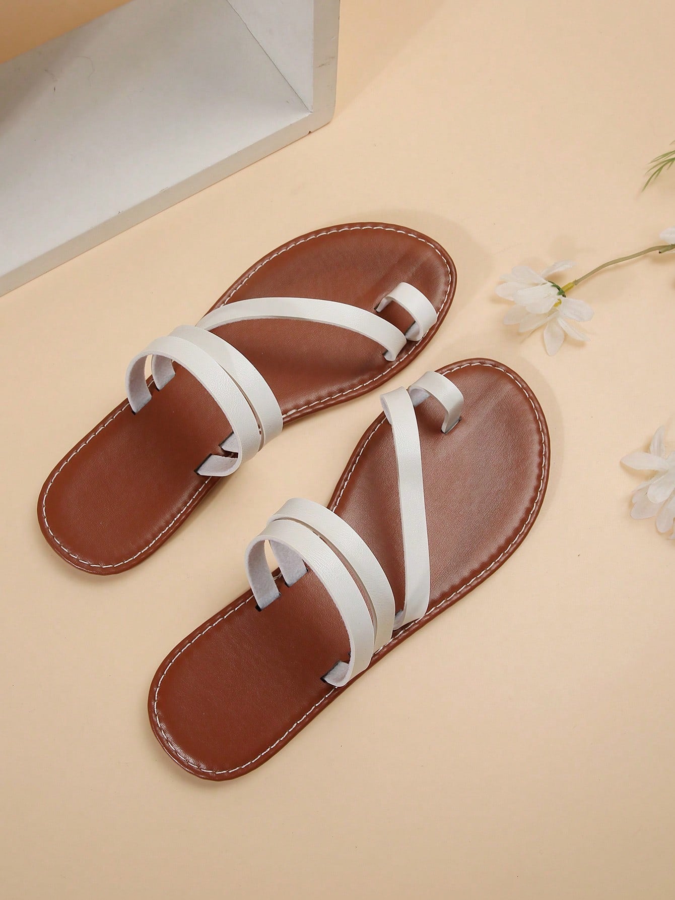 Women's flat slip-on sandal with toe ring and cross-over strappy upper, designed for casual beach and outdoor wear with an anti-slip sole.
