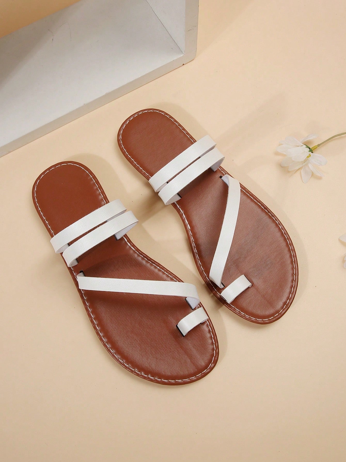 Women's flat slip-on sandal with toe ring and cross-over strappy upper, designed for casual beach and outdoor wear with an anti-slip sole.