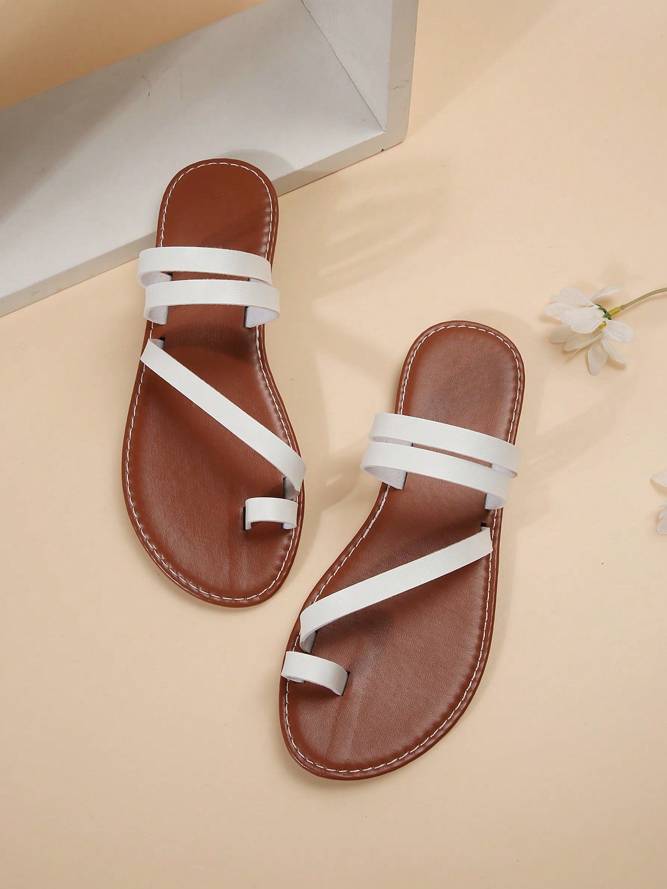 Women's flat slip-on sandal with toe ring and cross-over strappy upper, designed for casual beach and outdoor wear with an anti-slip sole.